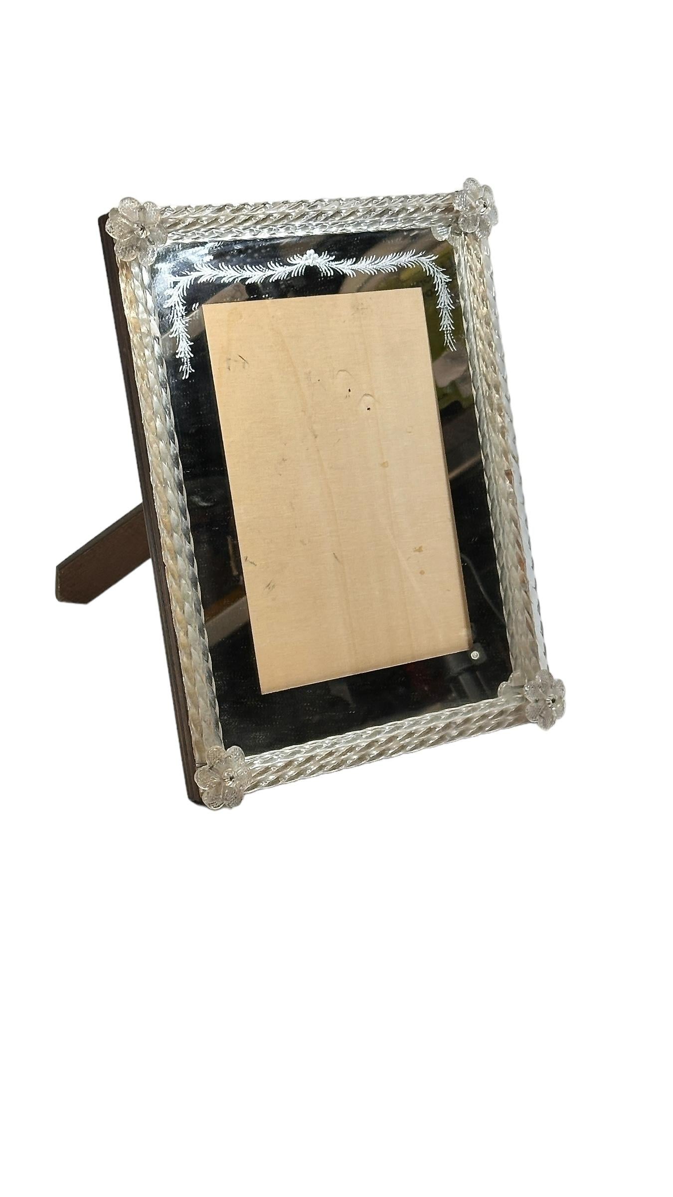 A gorgeous Murano glass picture frame surrounded with handmade gold flake clear glass flowers. With minor signs of wear as expected with age and use. It measures approximate 10.25