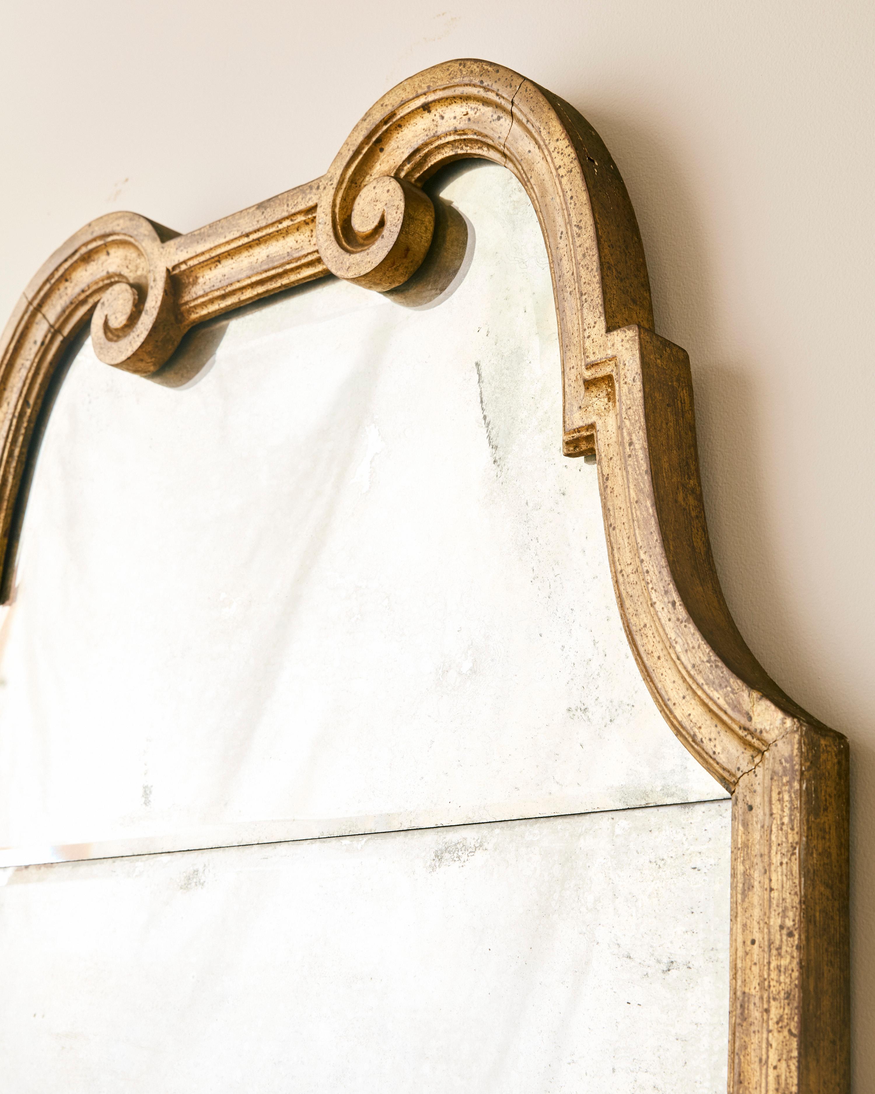 Large Italian Venetian style gilt mirror featuring two part beveled glass.