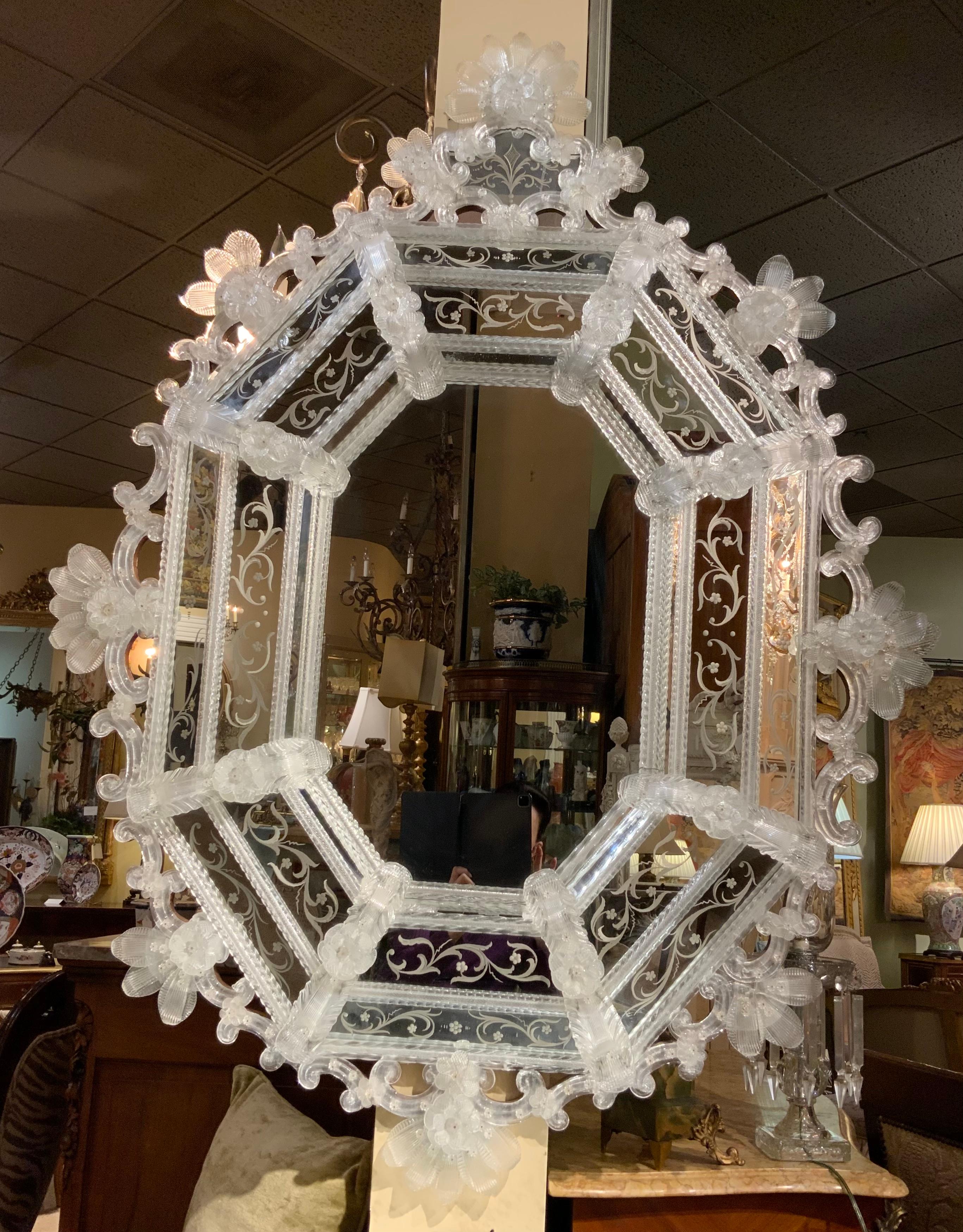 Large impressive and decorative mirror with multiple blown
Glass flowers and foliate elements that are surrounding
This mirror. All parts are in tact and without chips or missing
Pieces. Decorative etching adds beauty and interest to