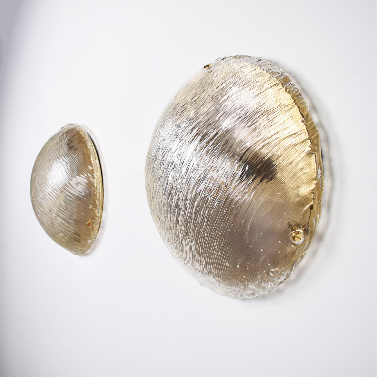 Large Venini ceiling lights attributed to Carlo Scarpa for Venini, 1950s. Wonderful light effect. The heavily textured and slightly iridescent glass dome is held in place by 3 brass knobs. High quality and in very good condition. 

Cleaned,