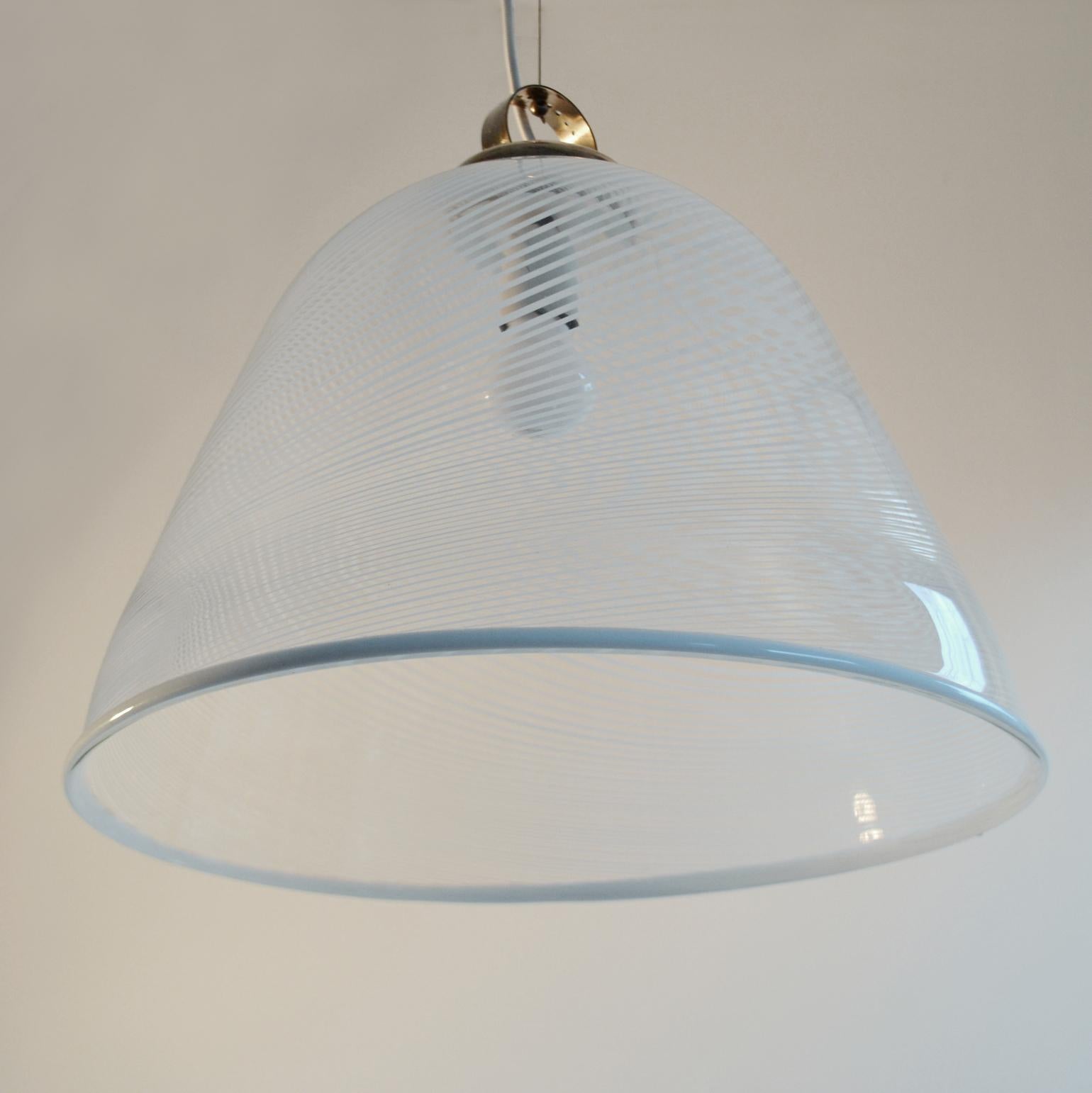 Large and exquisite blown crystal clear Murano glass dome shape lampshade decorated with spiraling white stripes of using the highly skilled Reticello technique that involves the merging of two glass cane domes (one inside the other) in which the