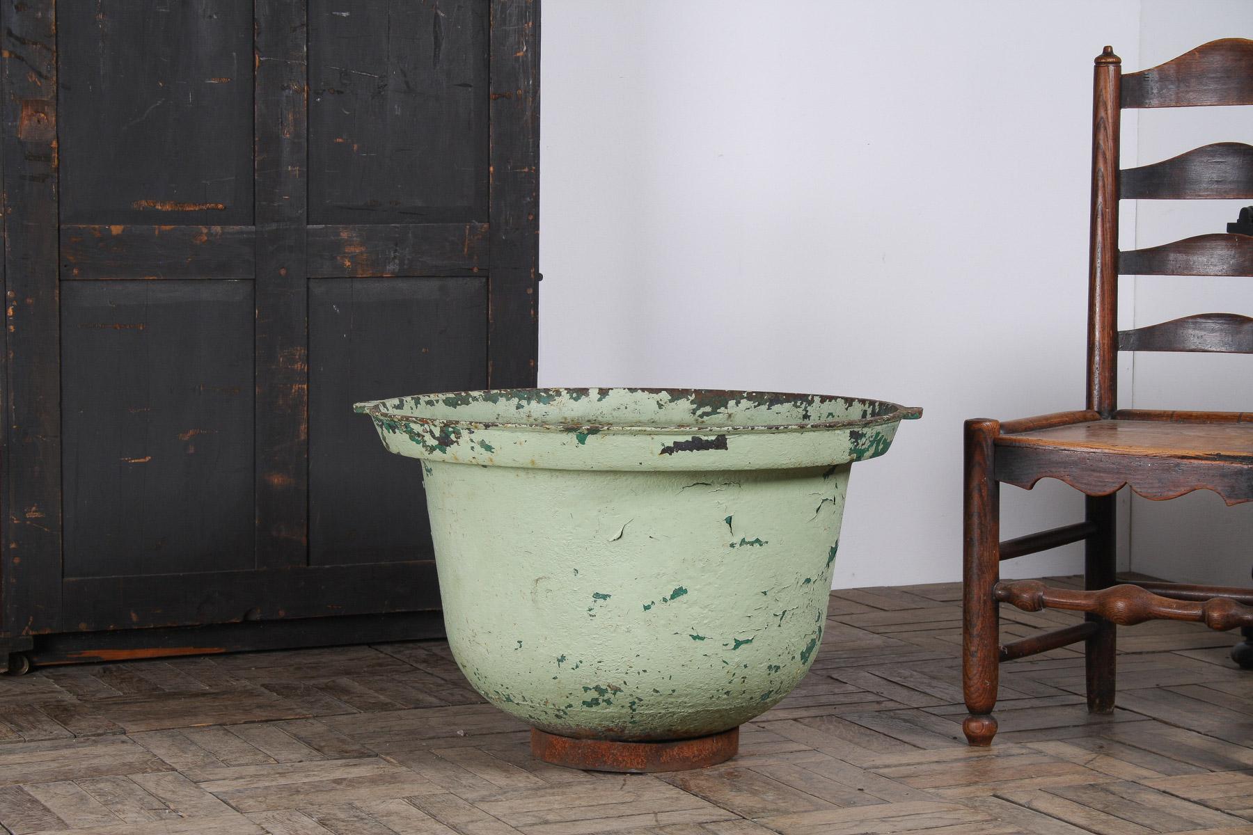 A Large Verdigris Green Painted Cast Iron Cauldron Garden Planter Pot of superb character, perfect for adding a striking focal point to your garden or indoor space. With a generous 30 inches in diameter, this piece commands attention.
Design and