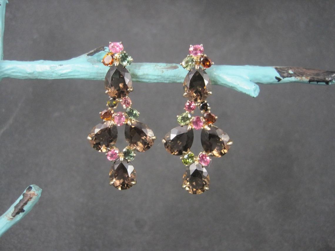 These gorgeous estate earrings are gold vermeil over sterling silver.
They feature a combination of pink and green tourmalines, citrines and stunning smoky quartz gemstones.

Measurements: 13/16 by 1 3/4 inches
Weight: 10.8 grams

Condition: