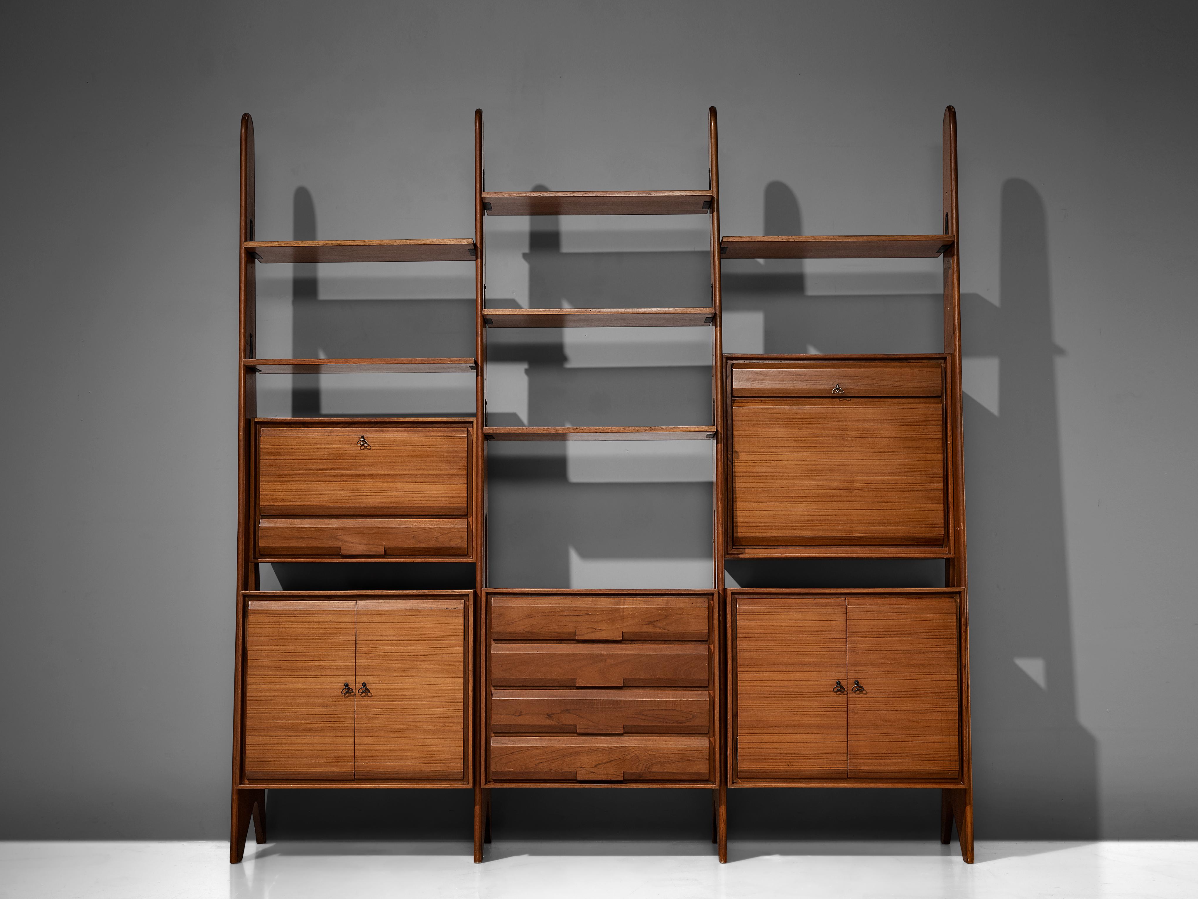 Large Italian shelf, wood, metal, Italy, 1960s.

The monumental wall-mounted cabinet consists of three compartments with various different storage facilities. The shelves and compartments are directly mounted on the brad wooden frames. The storage