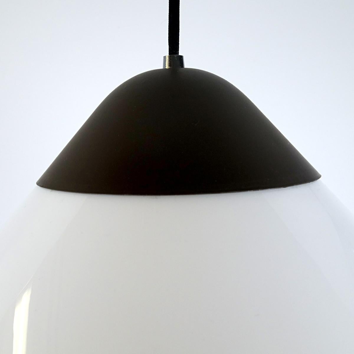 Large version of the Opala pendant that Hans J. Wegner originally designed for a Copenhagen hotel.
The shade is made of white acrylic held by dark grey steel.
Marked on in the inside by the Louis Pulsen label.