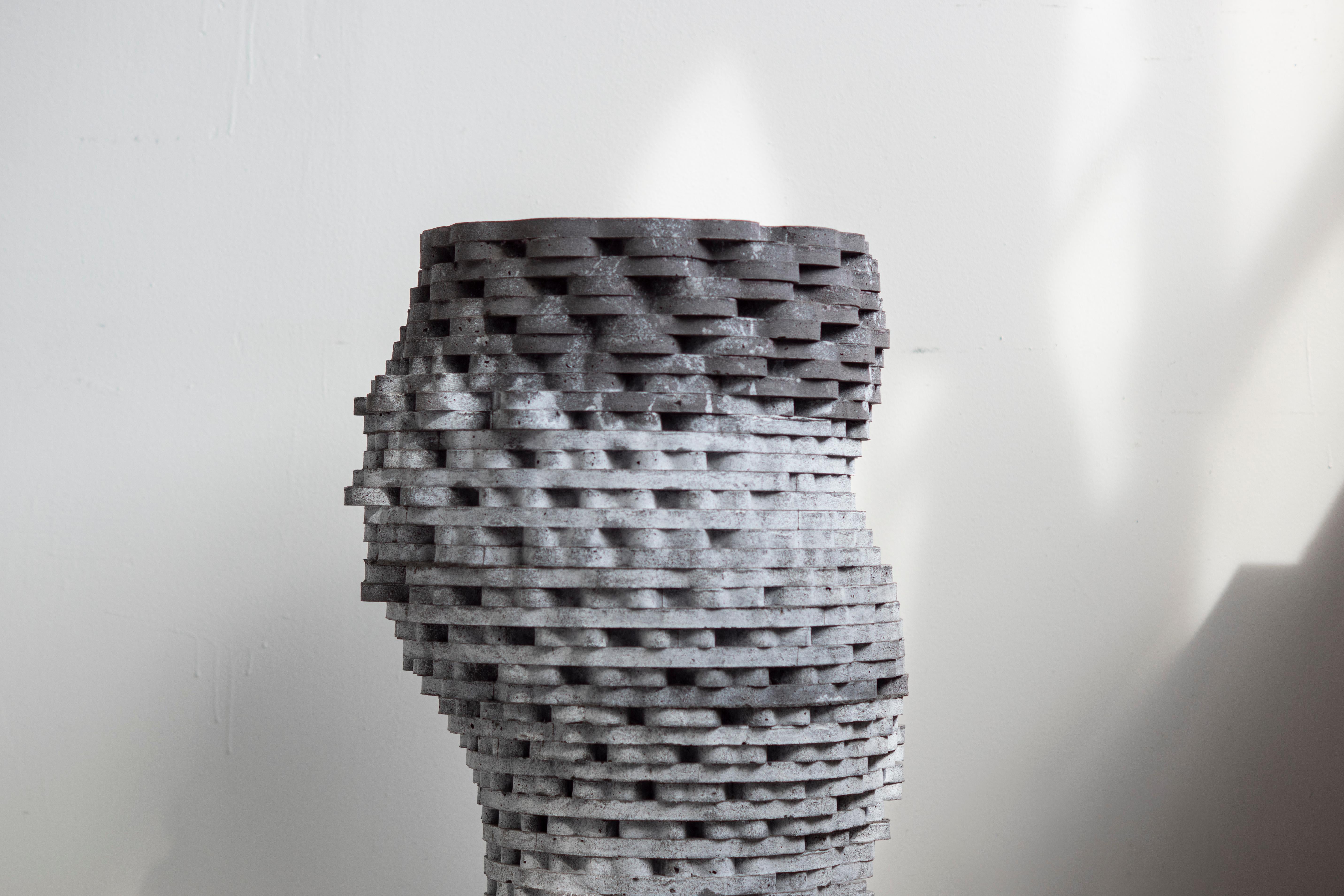 Large hand-cast vessel for indoor and outdoor use.

At the intersection of art, craft, and design, Concrete Poetics' debut collection of hand-cast cement sculptural furniture and accessories streamlines visually intriguing and dynamic forms