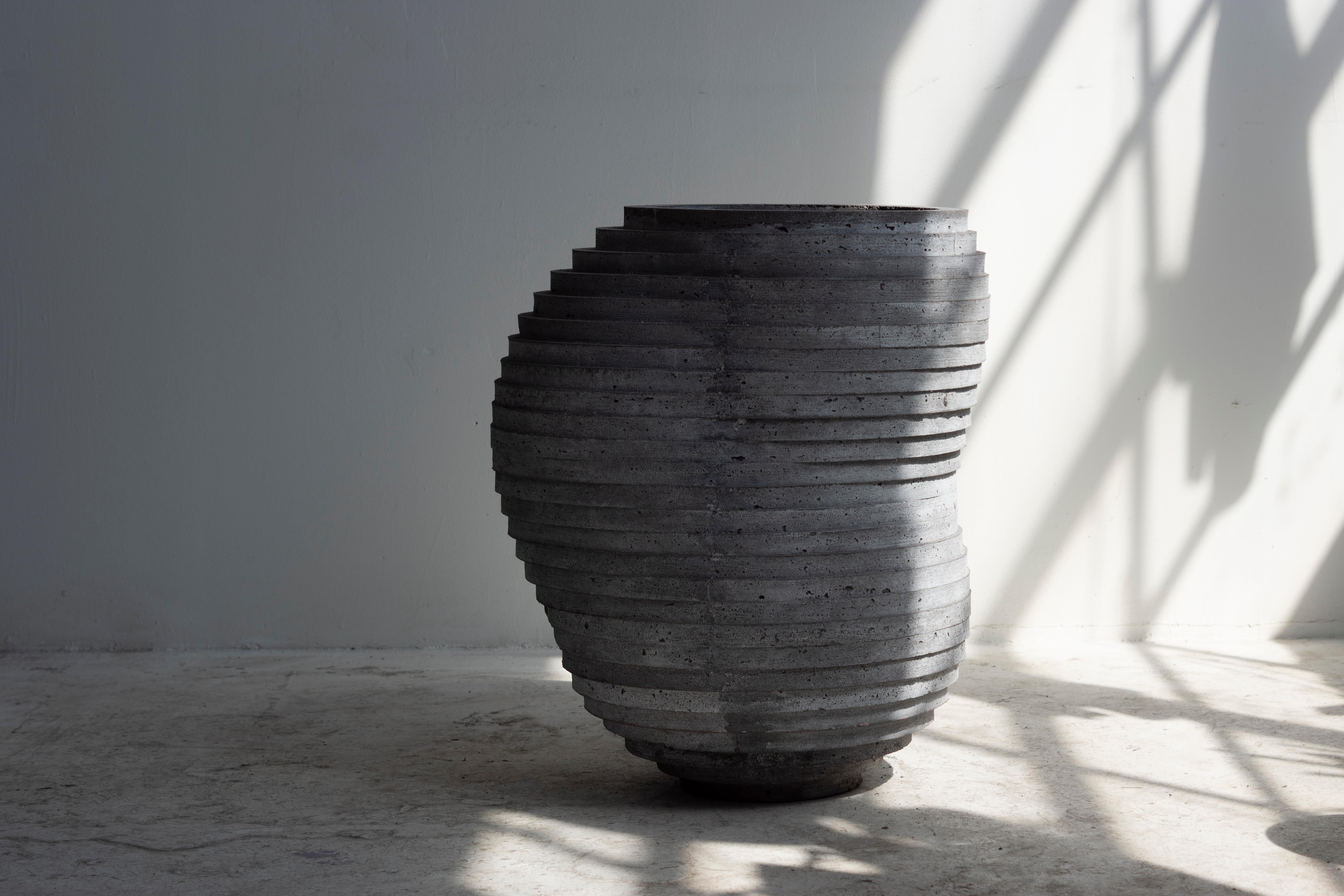 Large hand-cast vessel for indoor and outdoor use. Drainage holes can be added.

At the intersection of art, craft, and design, Concrete Poetics' debut collection of hand-cast cement sculptural furniture and accessories streamlines visually