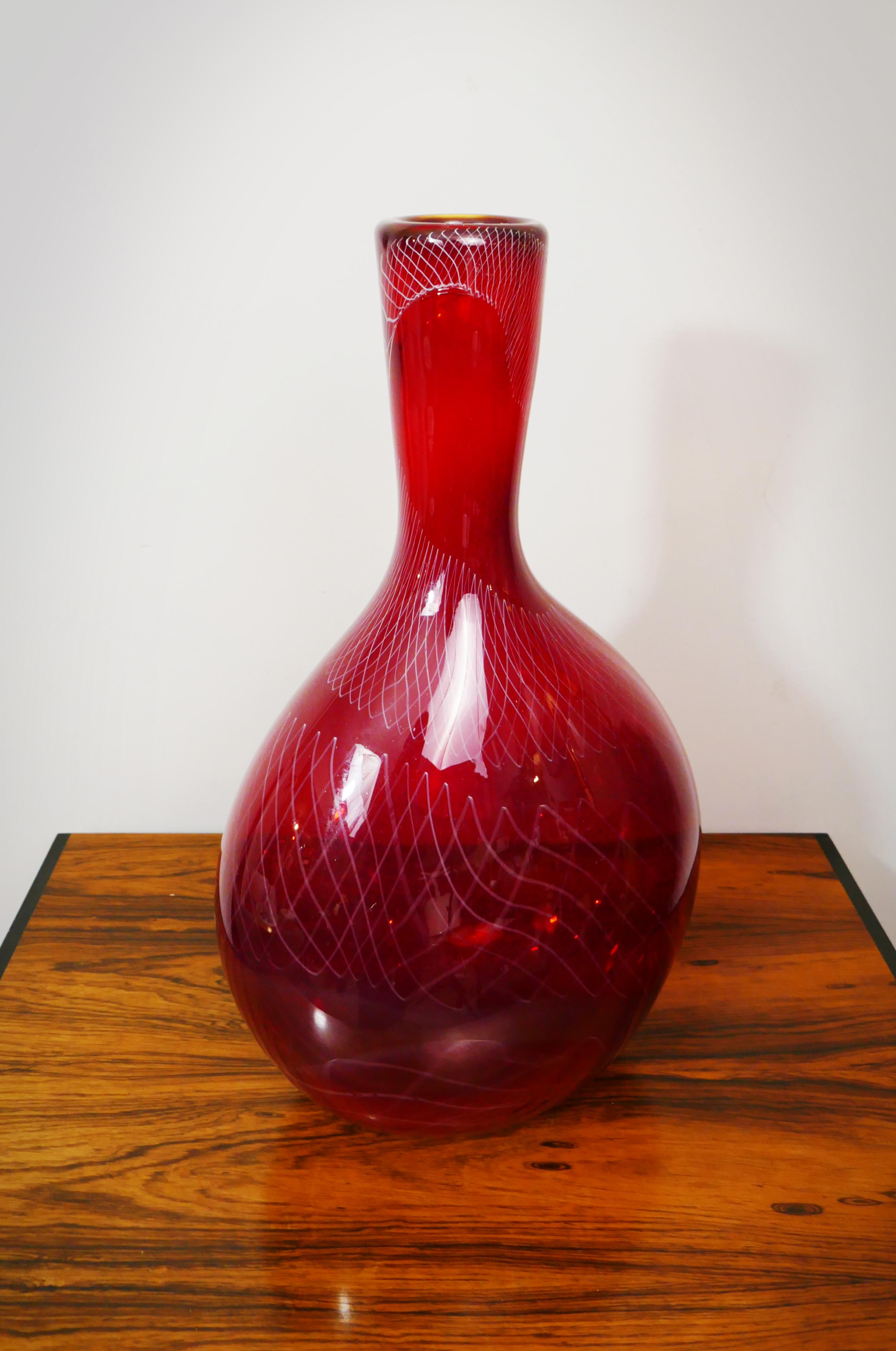 Large vibrant red Scandinavian glass vase with subtle criss cross white lines across the surface, 1970s.