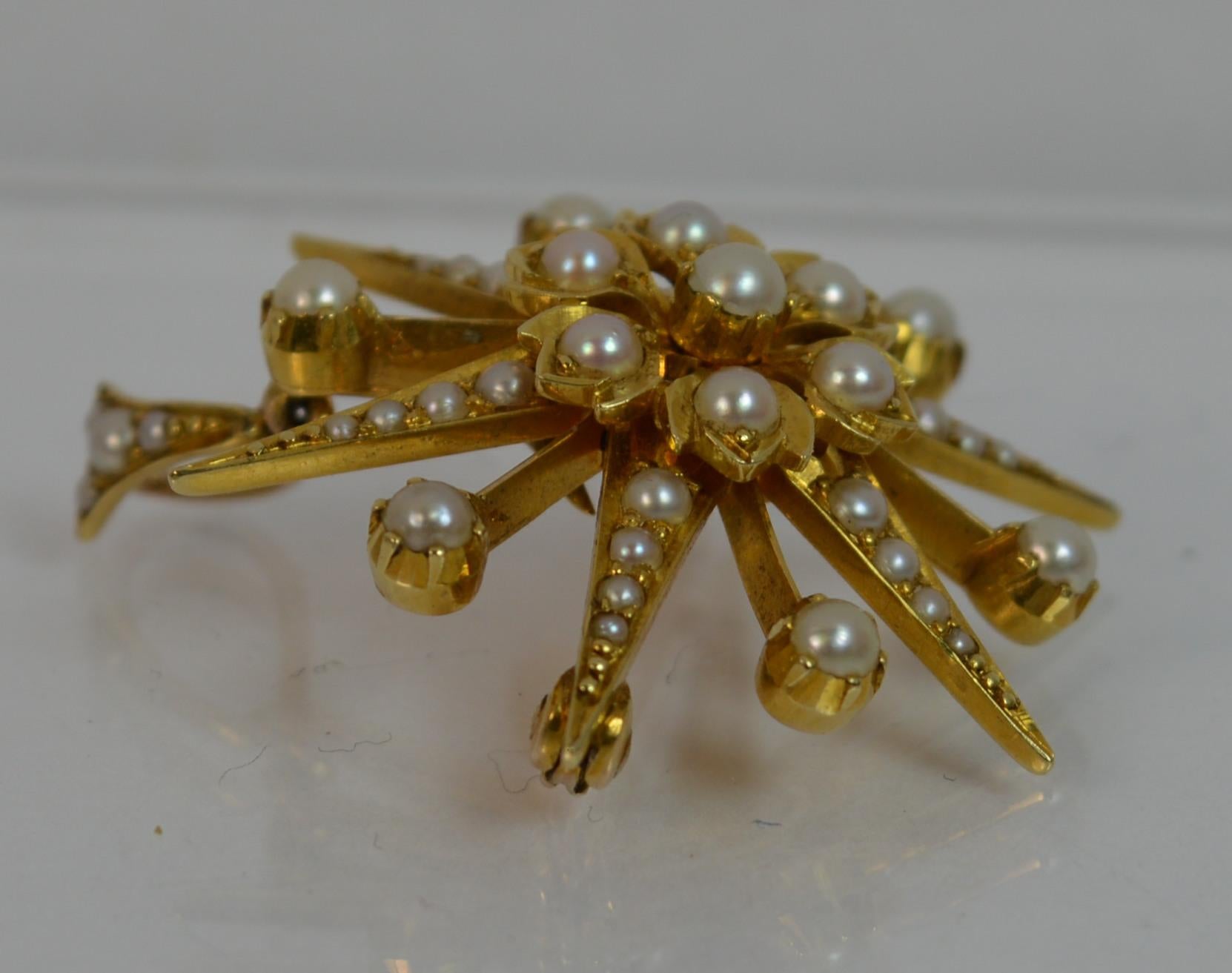 
A fantastic Victorian period pendant. Solid 15 carat yellow gold example. Set with a natural seed pearls throughout. Star shaped pendant. c1880. Very crisp example. 

CONDITION ; Very good. Clean piece. Crisp design. Issue free. Please view