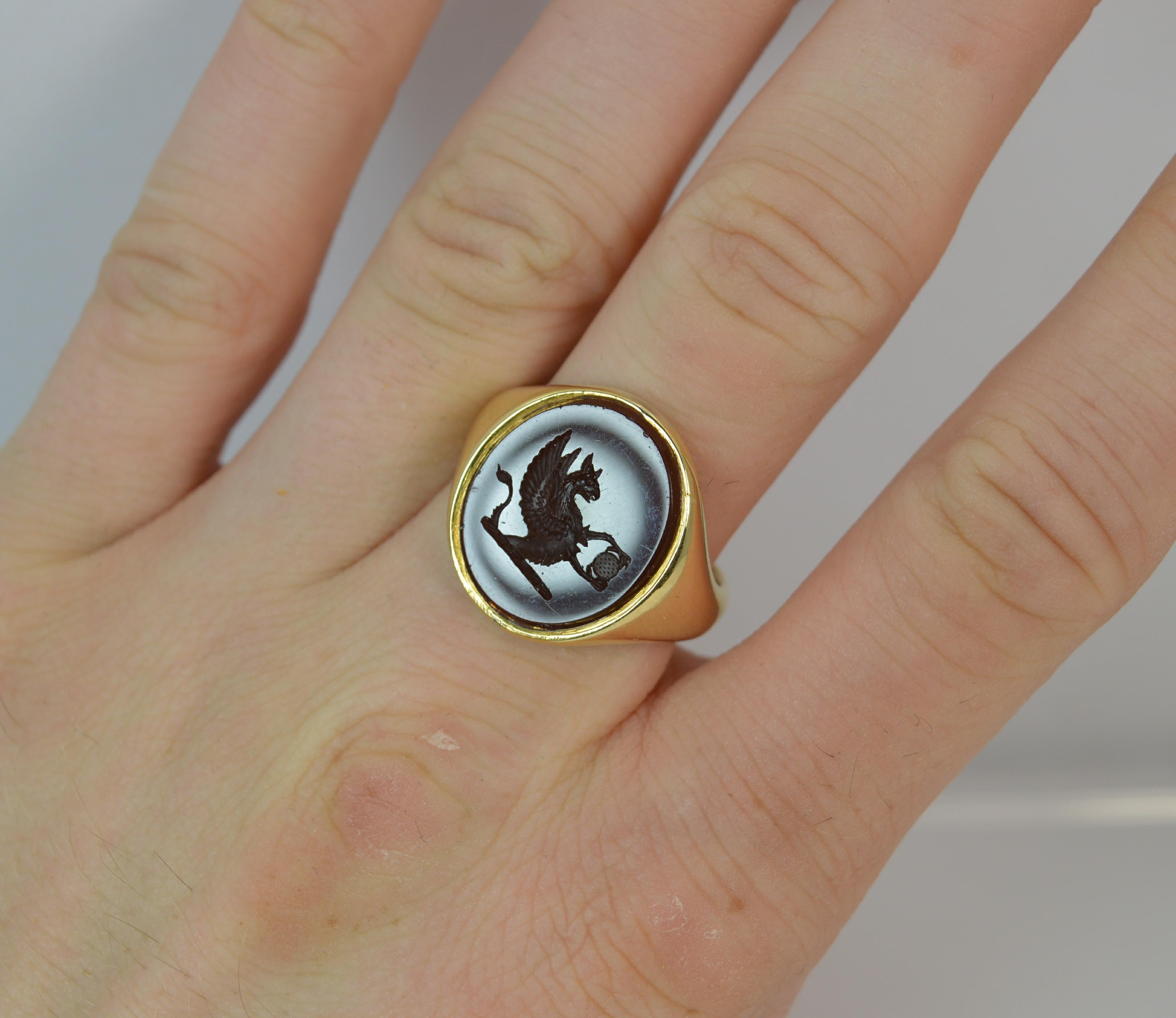 
A beautiful and excellent quality signet ring.

​18 carat yellow gold shank and setting.

​Designed with a large oval carnelian agate to centre, 15mm x 17mm approx with a very finely engraved intaglio.

​The intaglio or seal is of a Griffin with