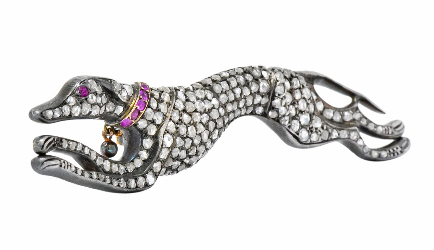 Designed as a greyhound, mid-run, set throughout with rose cut diamonds weighing approximately 3.25 carat total

Accented by rose cut and old European cut rubies on collar and eye weighing approximately 0.22 carat total, raspberry red in color

3.47