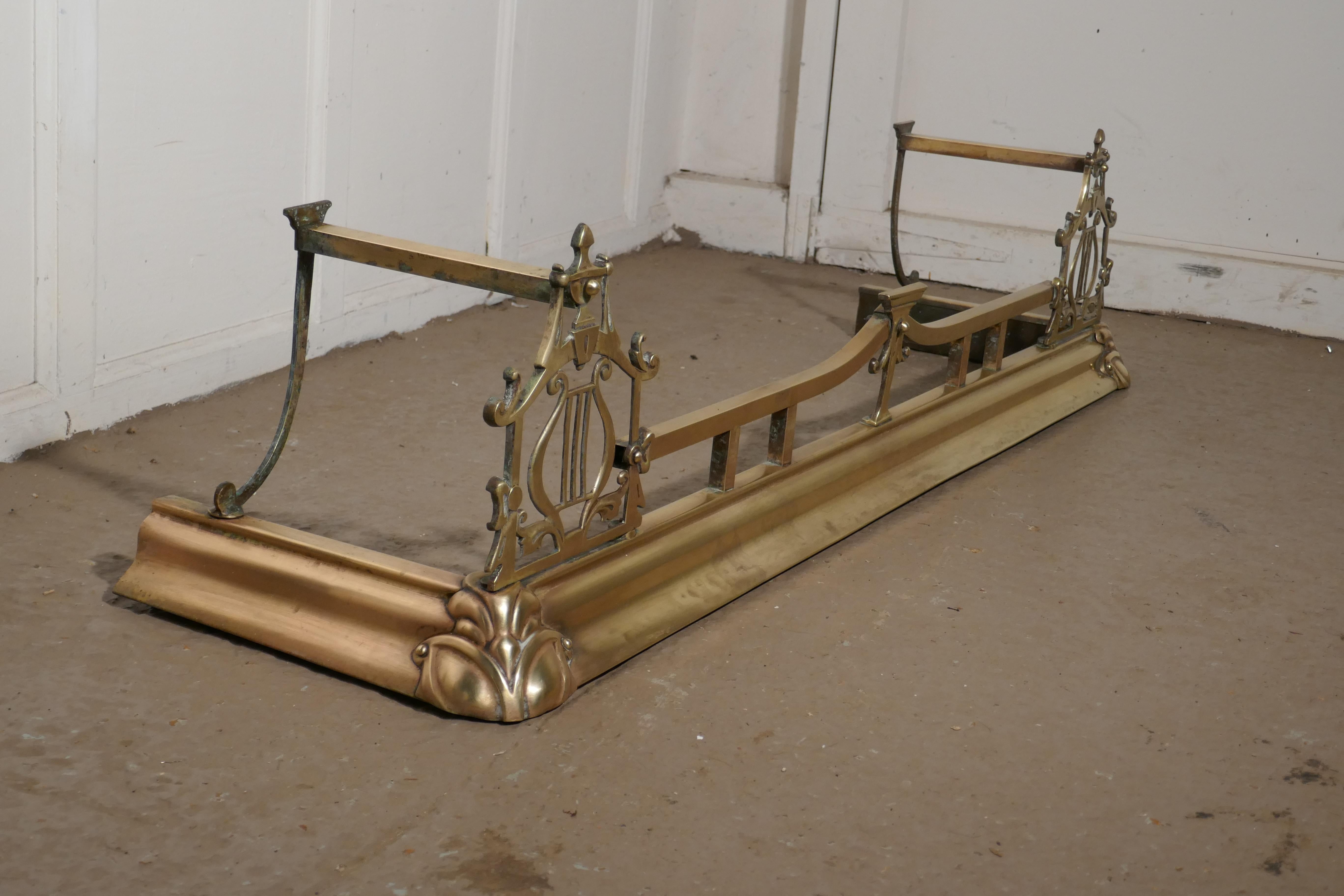 Large Victorian Art Nouveau brass fender

This is a beautifully designed Victorian brass fender it has an Art Nouveau musical themed decoration worked in brass
The fender is in fair condition (few bumps on the base at the front)it is 13” high,