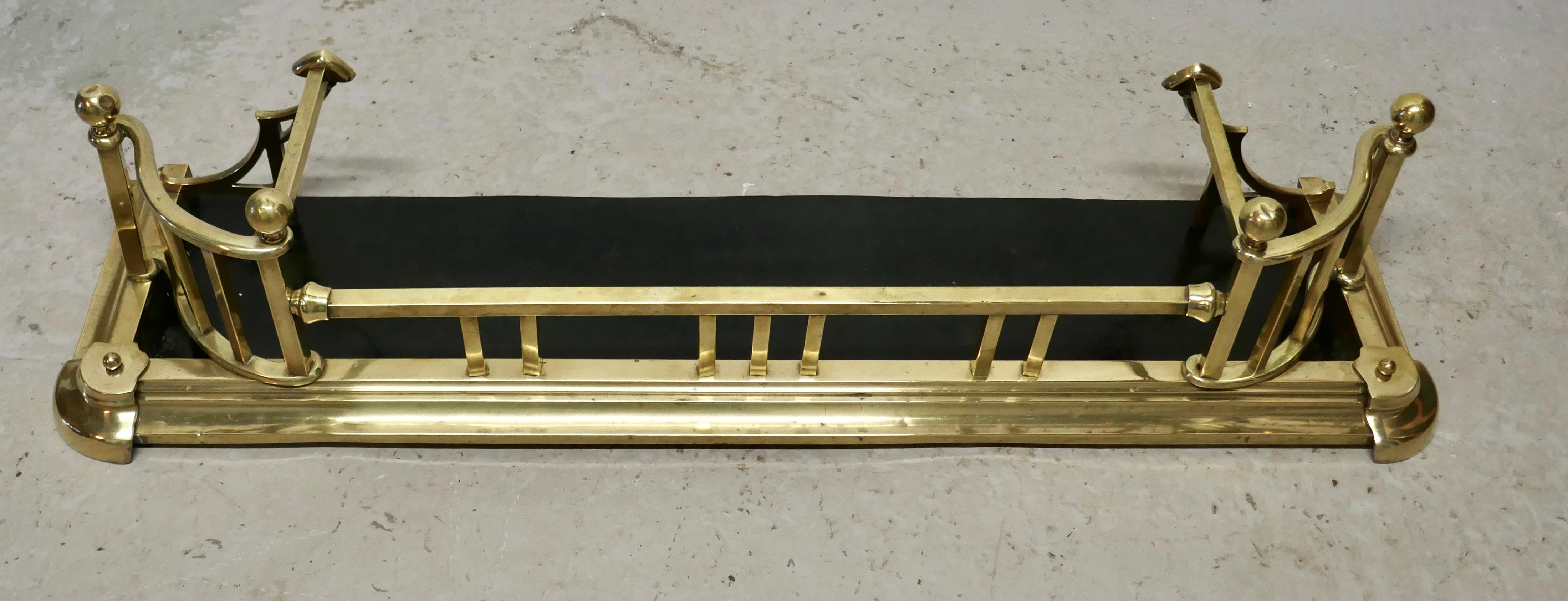 Large Victorian Arts & Crafts brass fender

 This is a beautifully designed brass fender it has a superb brass surround with rests on each side to lay your fire irons tools and chunky brass knobs 
The fender is in very good condition it is 12”