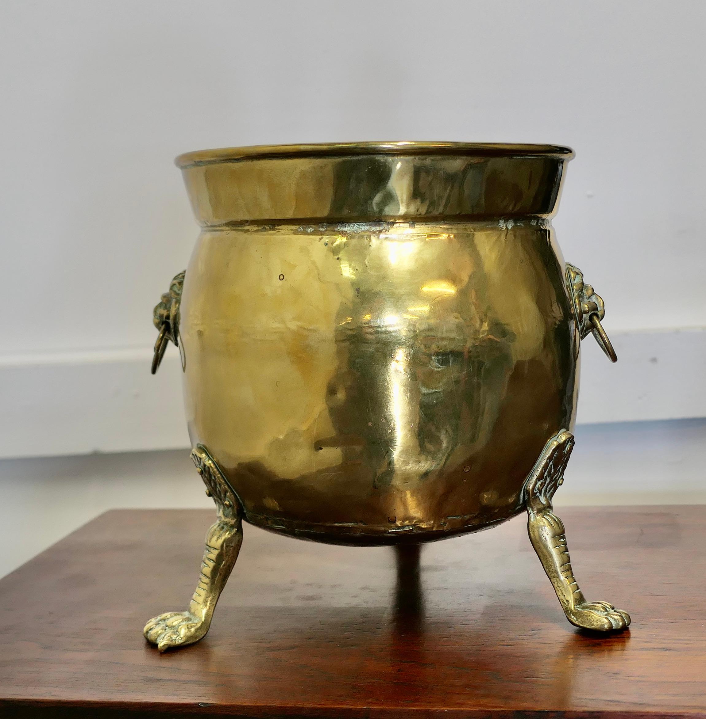 Large Victorian Brass Jardinière with Lions Mask & Hairy Paw Feet  

This a fine quality piece of solid brass hand made craftsmanship, the Jardinière has a rolled top edge, 2 lions mask ring handles and it stands on 3 hairy paw feet. 
This is an