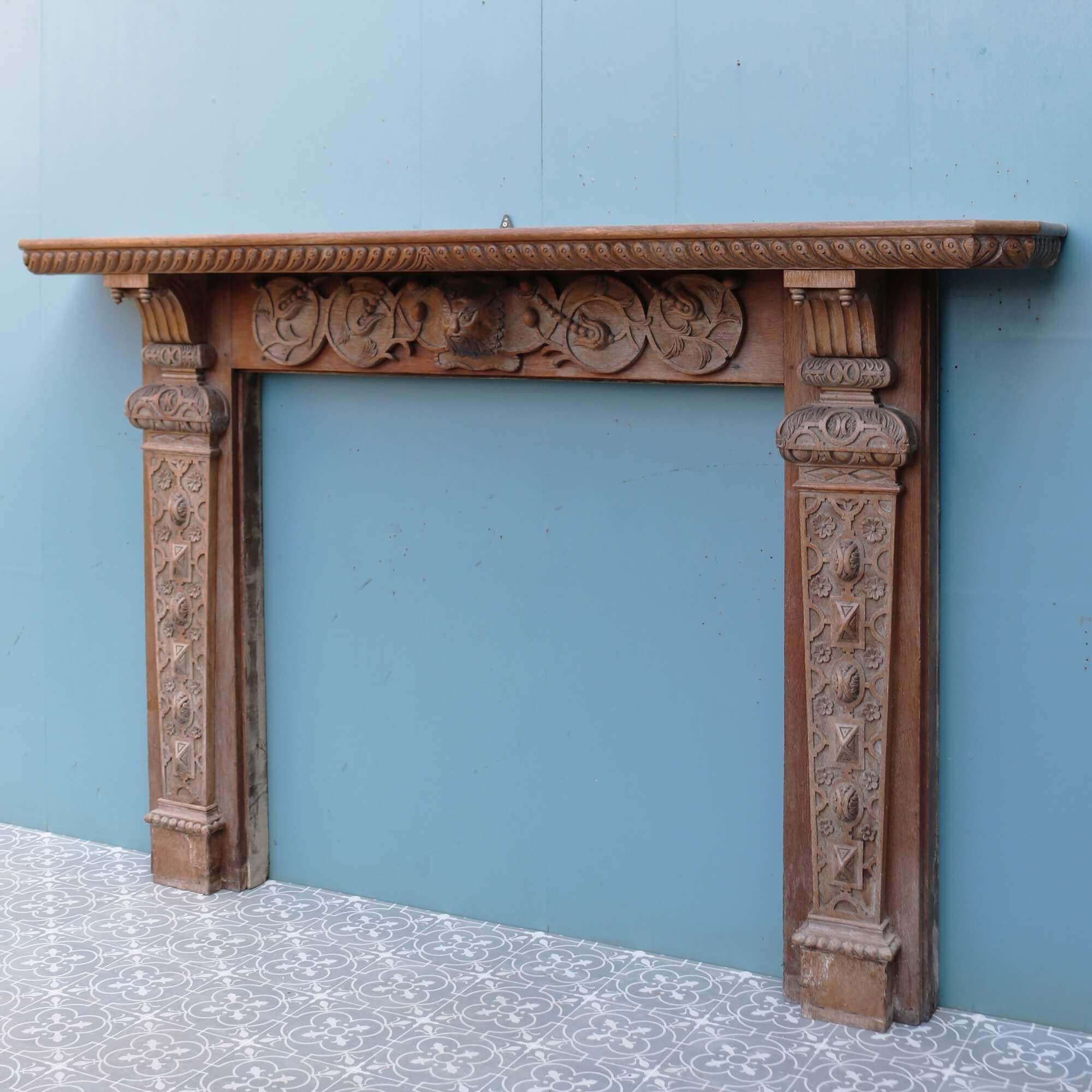 This very large scale carved oak fire mantel is a time-capsule into history. Hand-carved by a talented craftsman at the end of the 19th century, it features a decorative frieze and jambs with an ornate central mask of the Green Man, a legendary