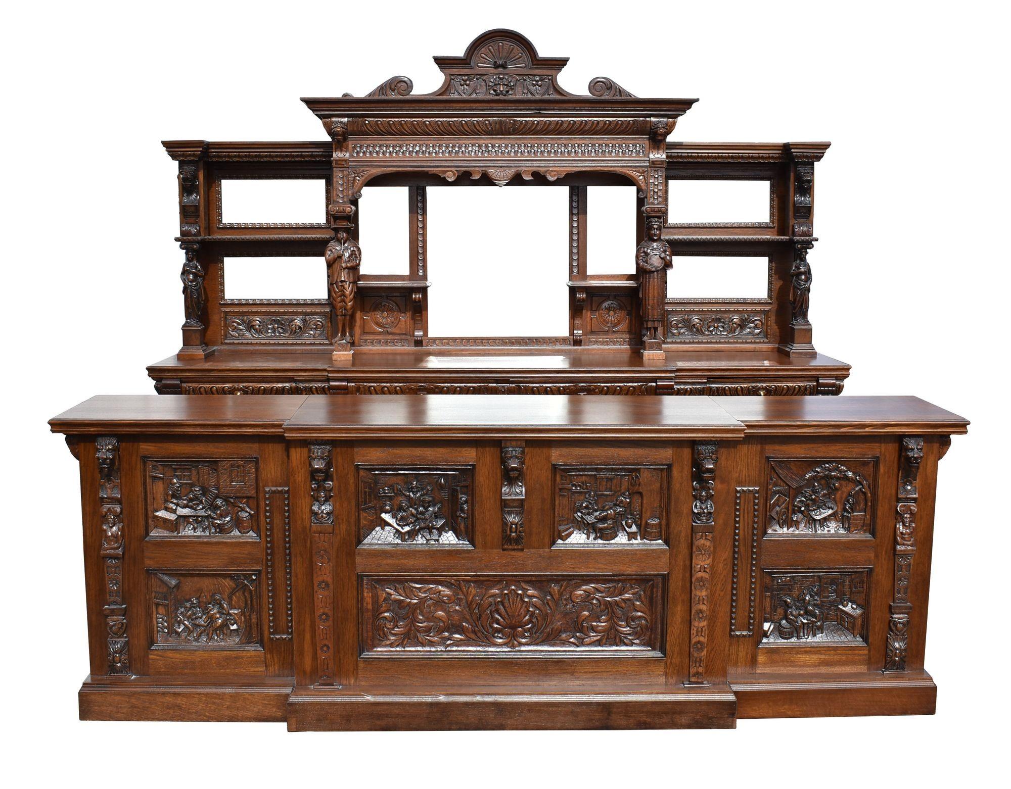 For sale is a good quality Victorian carved oak front and back bar, having an ornate carved lion pediment, with a mirror back below with carved figure supports, flanked by a wing on either side, each with intricately hand carved panels and