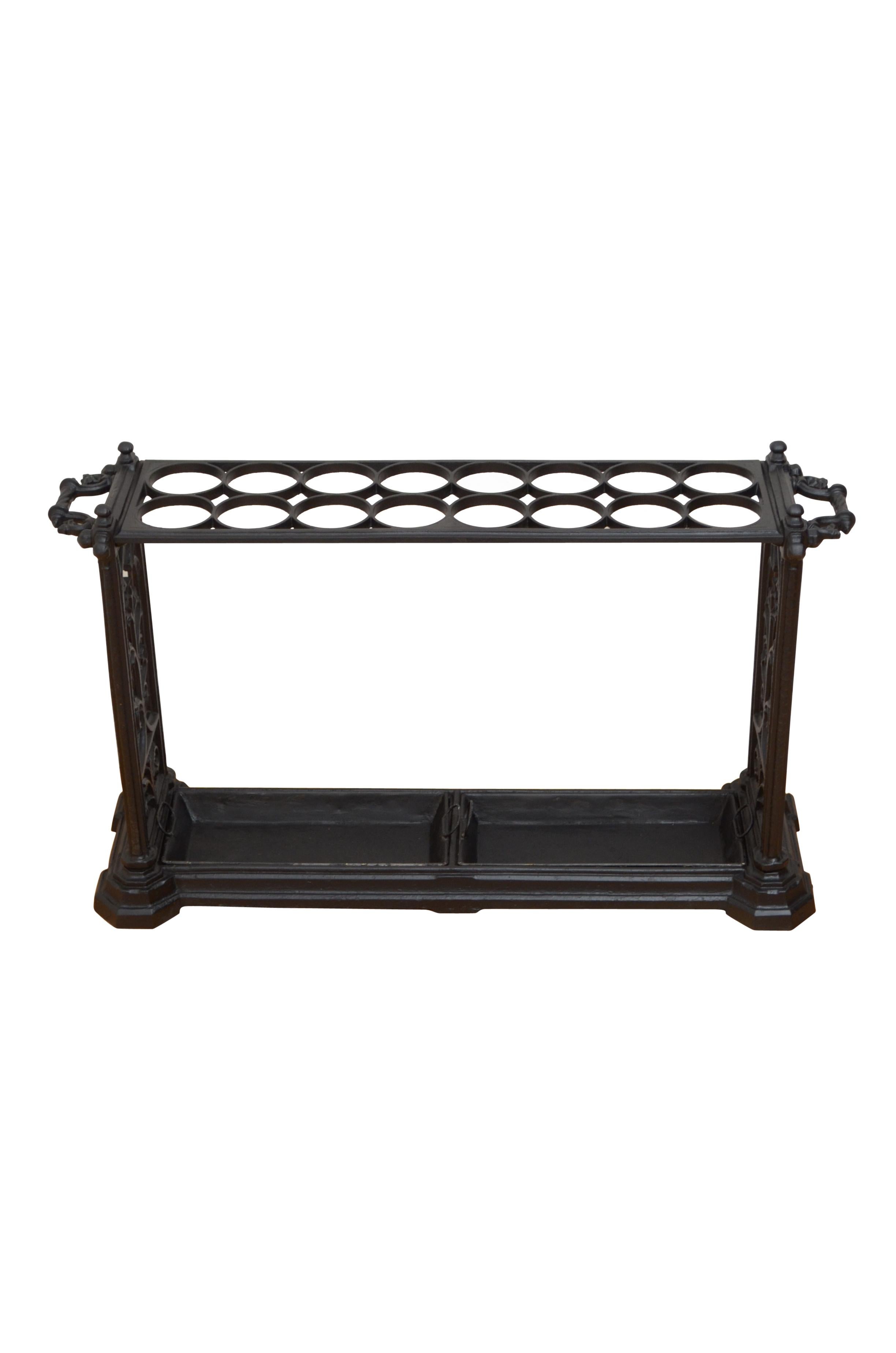 K0548 A large Gothic Revival Victorian cast iron umbrella stand / hall stand, having two row of eight umbrella compartments flanked by decorative finals and handles, supported on gothic design uprights terminating in stepped base with two removable
