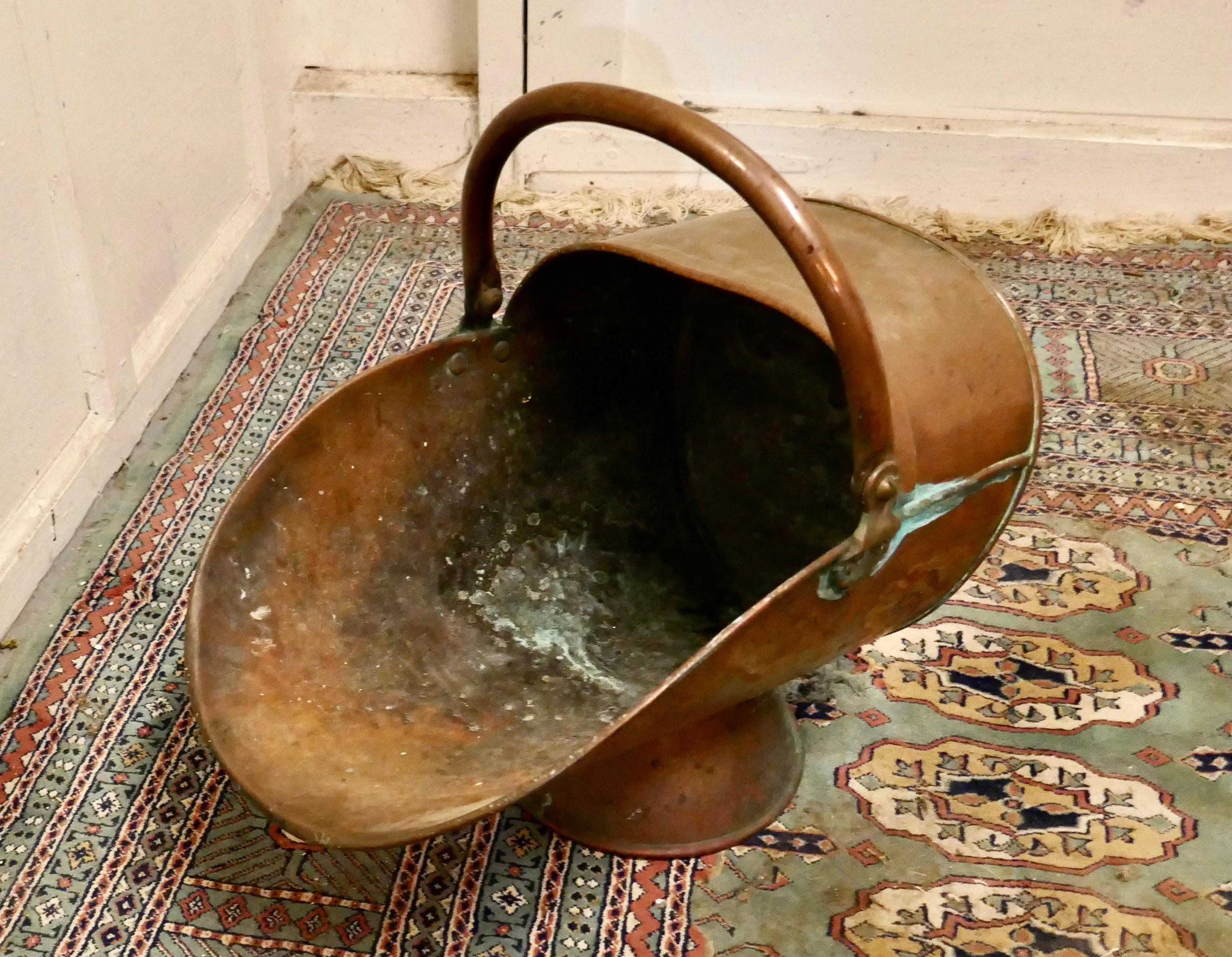 Large Victorian copper helmet coal scuttle 

This is a good quality piece has good shape, and a high base foot

The scuttle is in good condition it has been left un polished and with a natural patina, it has no faults just lots of character and