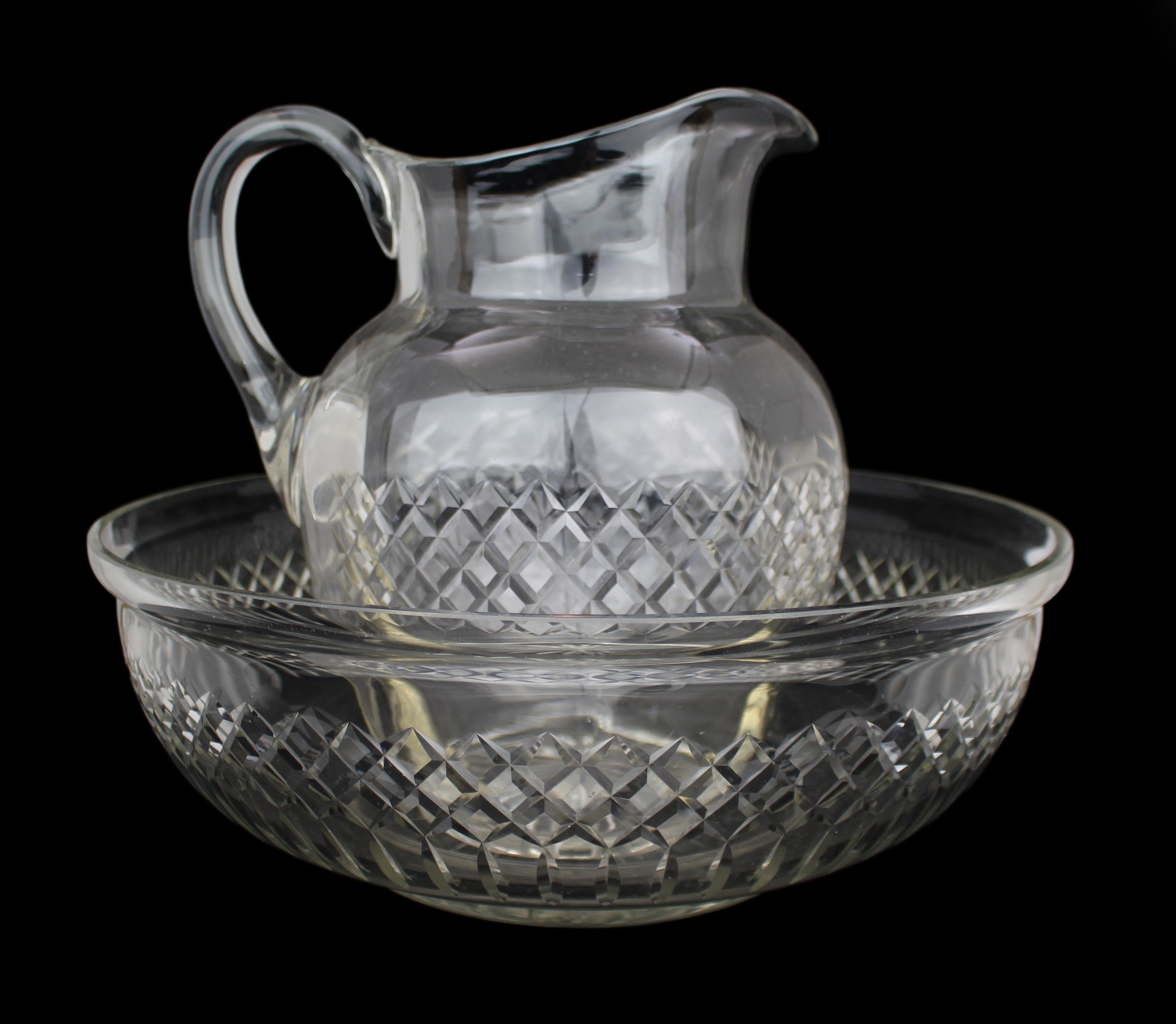 Large Victorian Cut Crystal Jug & Bowl Set
England, circa 1870–1900

A fine and impressive large-scale Victorian cut crystal jug and matching bowl.

Both pieces are beautifully hand-cut with bold cross-cut diamond decoration and star-cut bases,