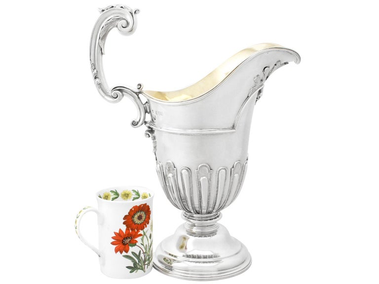 A magnificent, fine and impressive, large antique Victorian English sterling silver wine ewer made by Goldsmiths & Silversmiths Co Ltd in the George I style; part of our wine and drinks related silverware collection.

This magnificent antique
