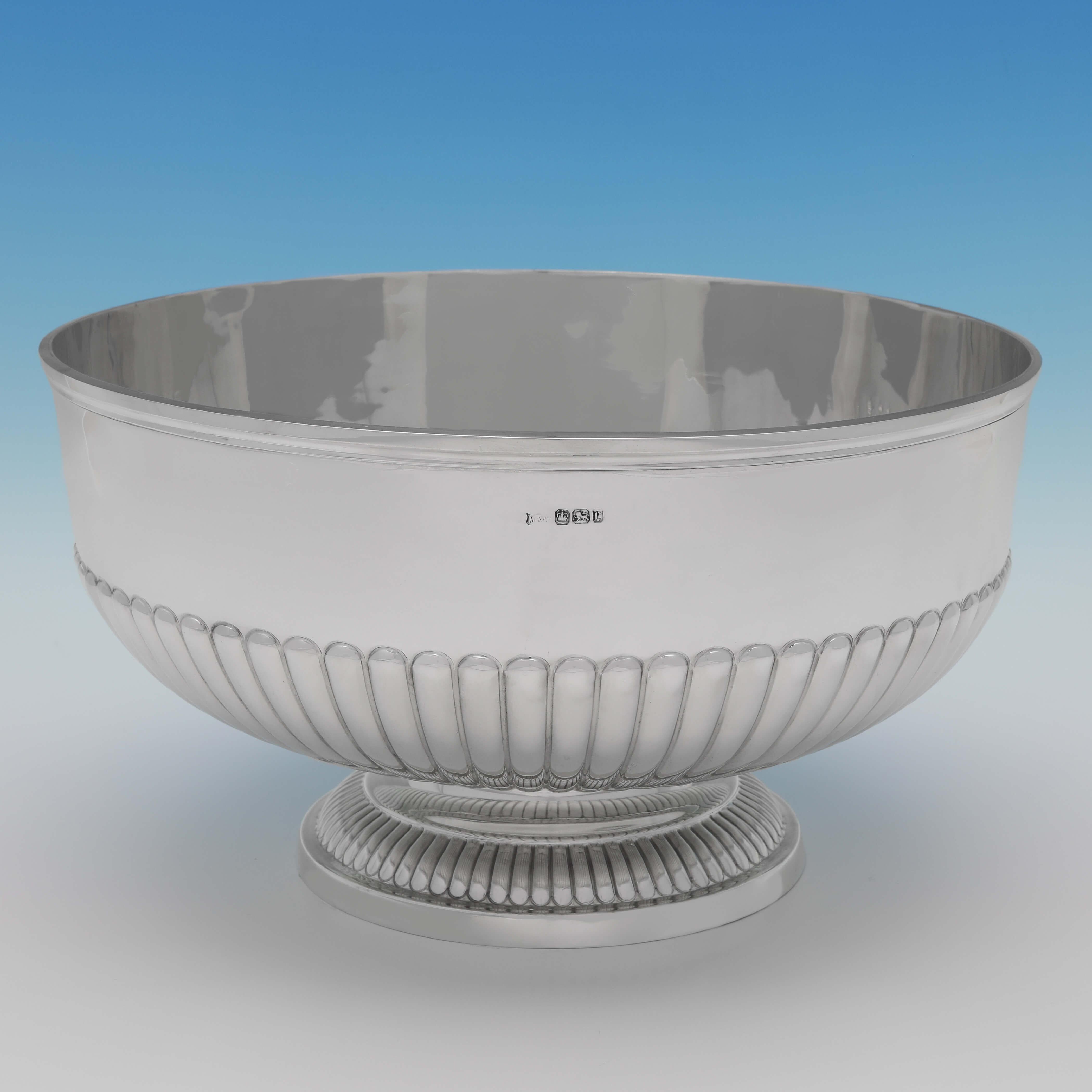 Hallmarked in Sheffield in 1895 by Mappin & Webb, this handsome, Victorian, Antique Sterling Silver Bowl, features half fluting and reed borders. The bowl measures 6.75