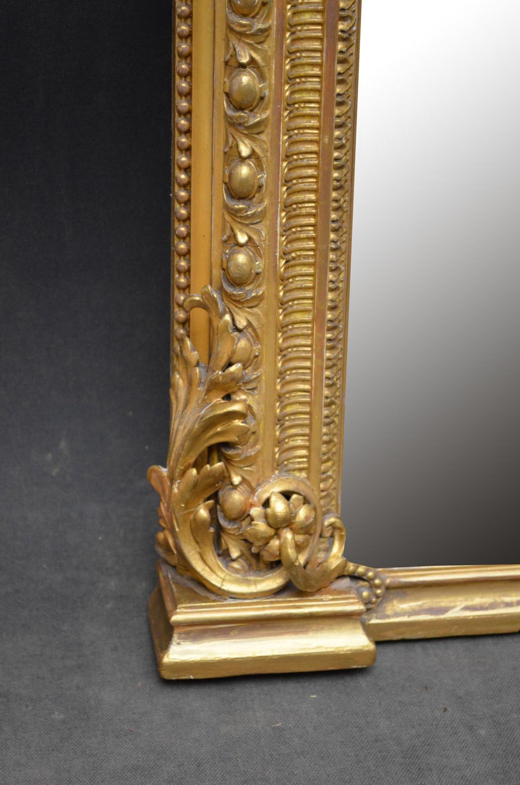 J00, exceptional Victorian giltwood mirror, having original mirror plate with some foxing in finely decorated frame. This antique mirror retains its original mirror plate, original gilt and paneled backboards, all in home ready condition, circa