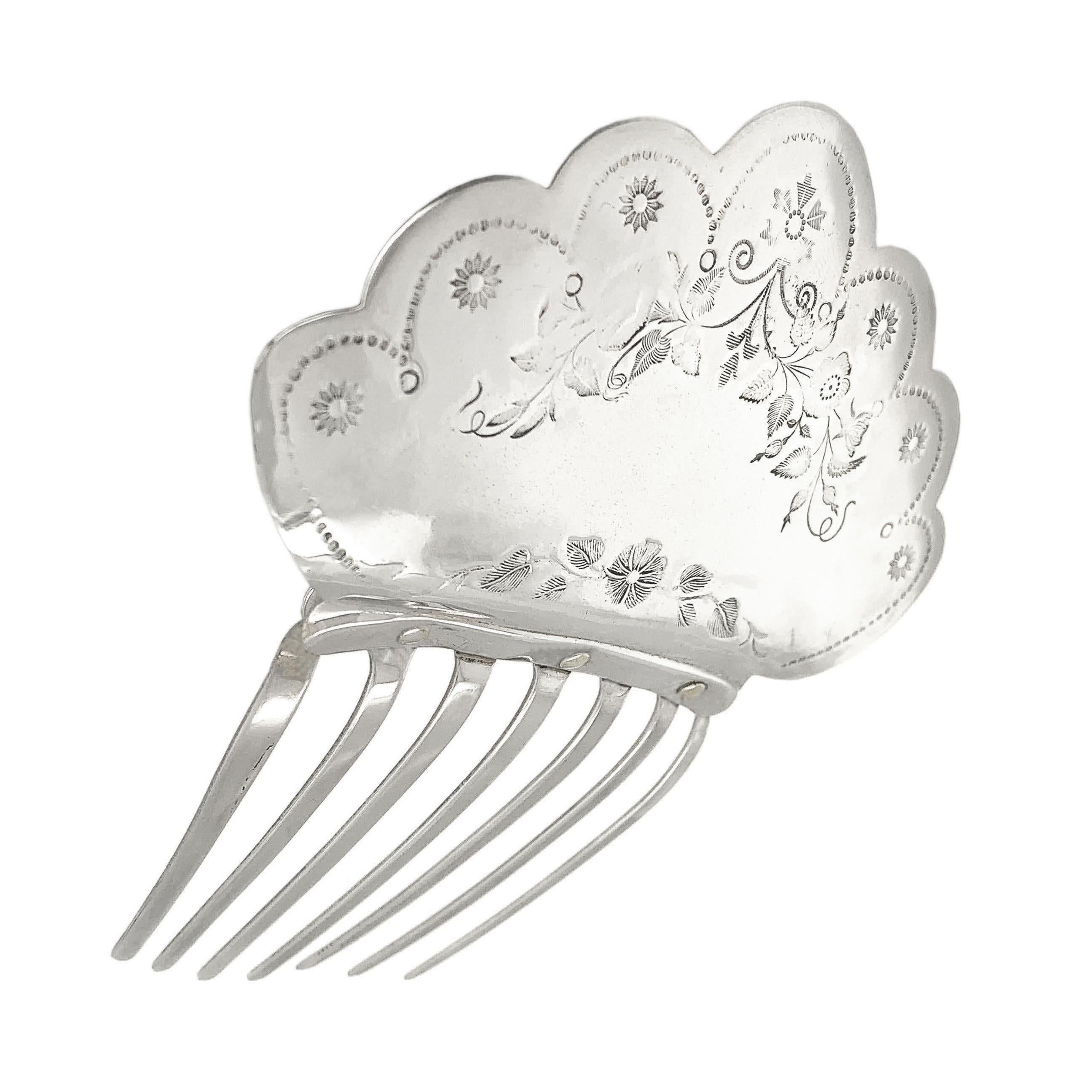 Large and glamorous Victorian hair comb.  Embellished with fine bright-cut engraved floral pattern.  Silver-plated.  4