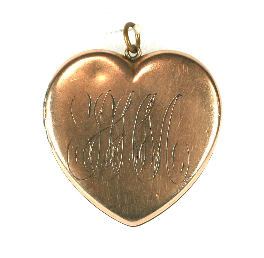 Large scale Victorian gold filled heart locket with 2 sided overlapping, scrolled monograms. 
1880's USA. Good Condition.
1.75