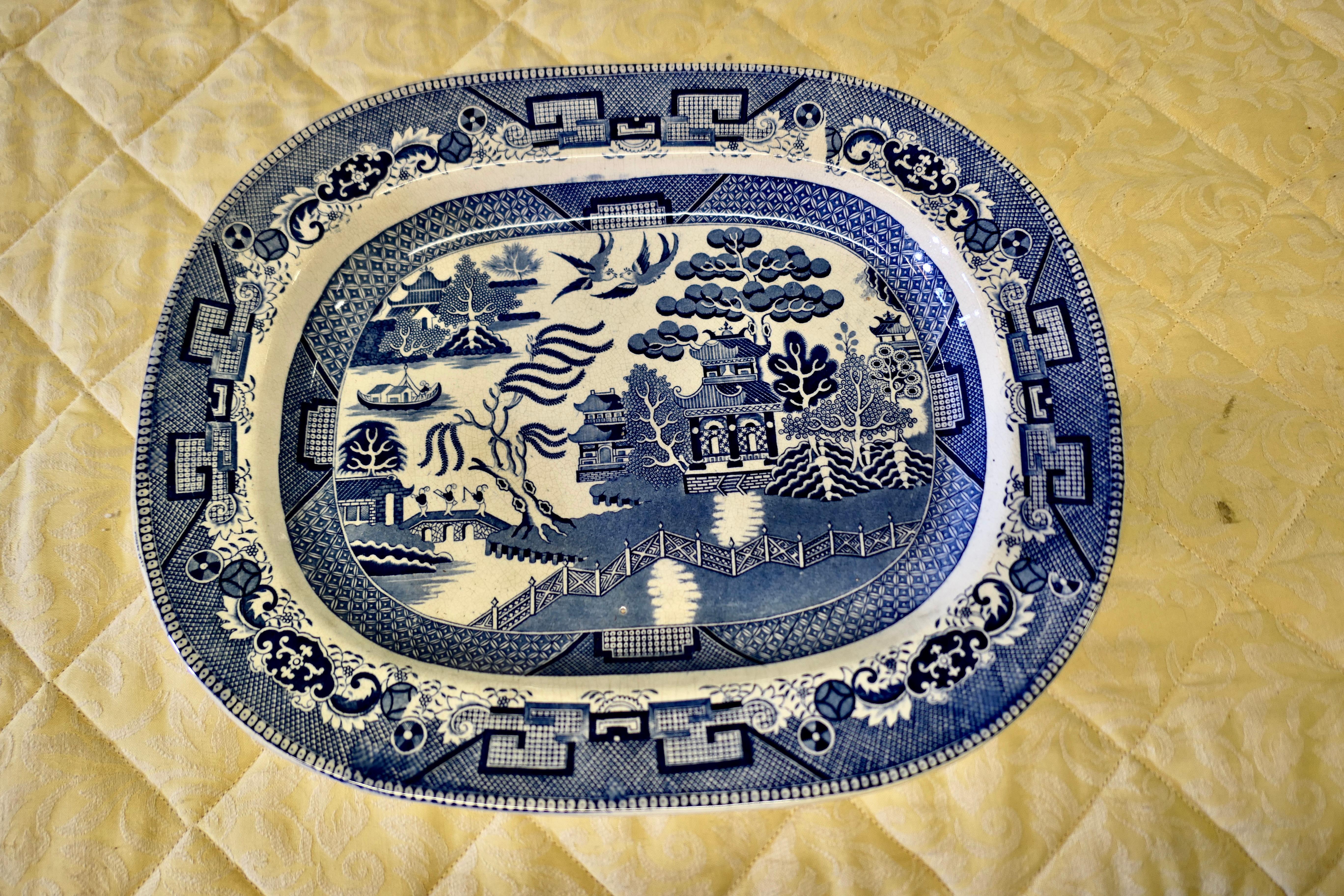 Large Victorian Ironstone Willow Pattern Meat Plate 

A lovely piece with timeless design and  good colours, the plate deep and has a wide edge, it is in good condition with some age related crazing to the finish

The plate is 18” long wide 14.5”