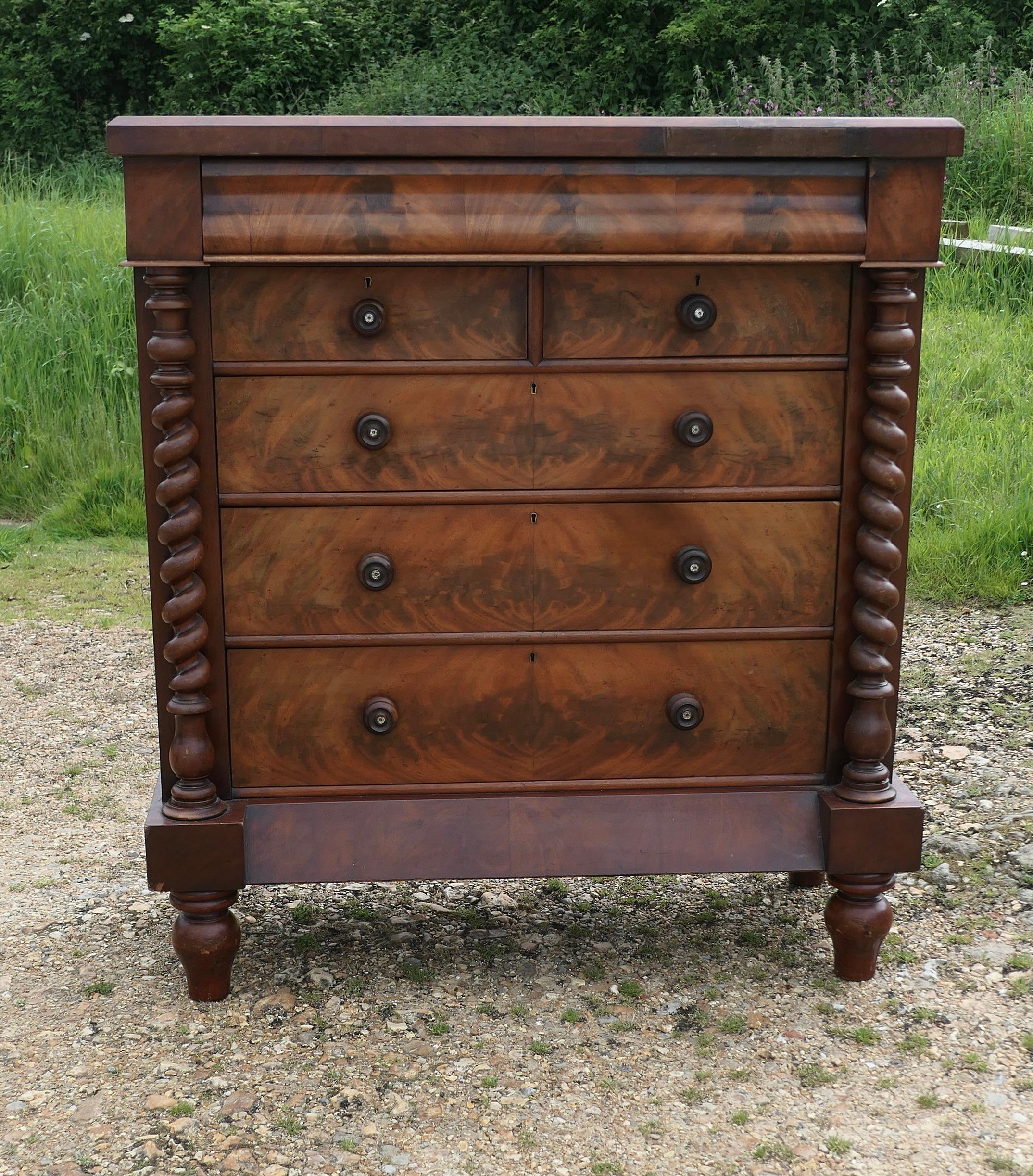  Large Victorian Mahogany Chest of Drawers, Scotch Chest

 The chest is Heavy Quality and has well figured Flame Mahogany Veneers with large barley twist pillars on either side and it has an attractively shaped top with a secret drawer. 
The Chest