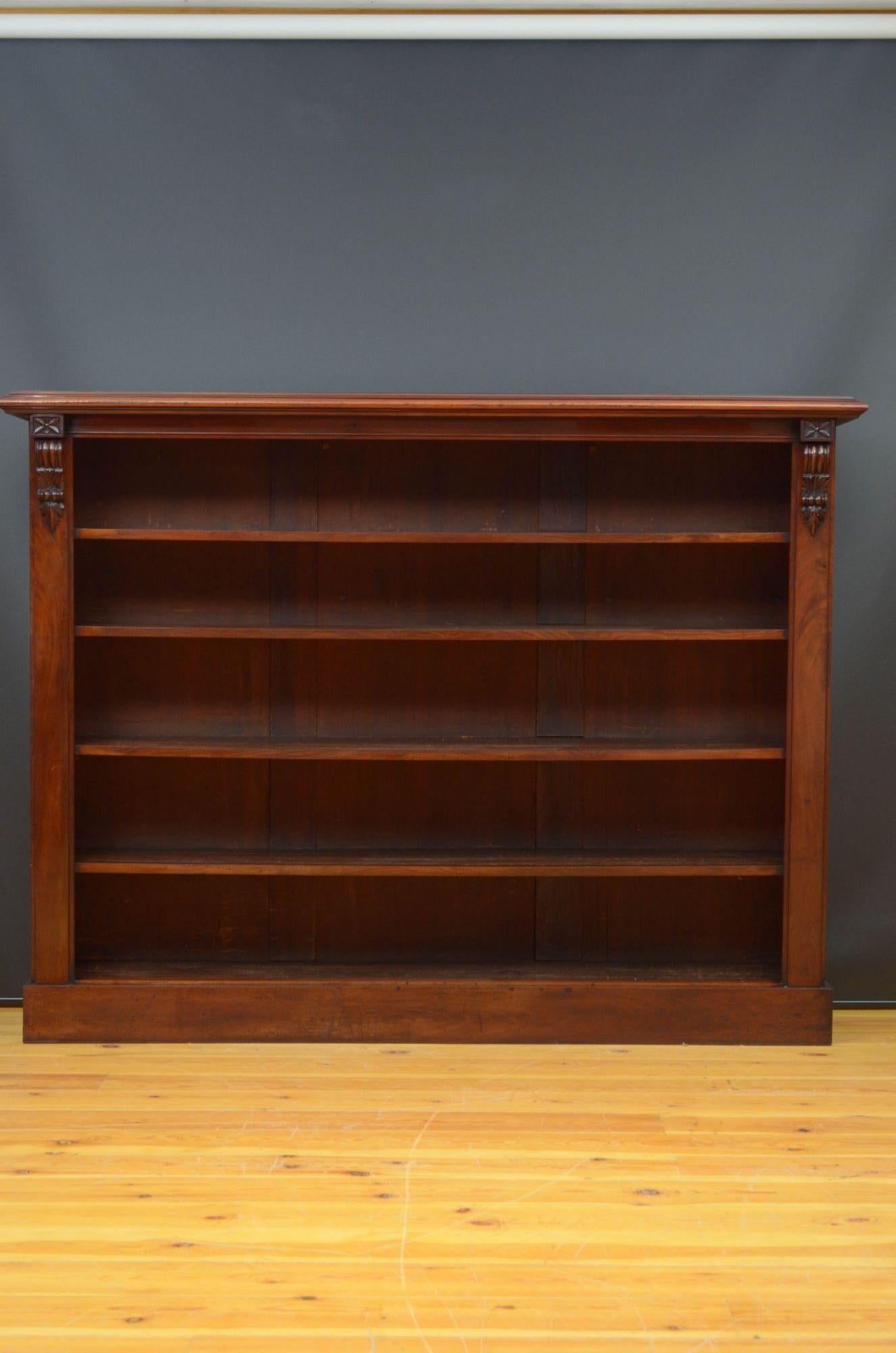Sn5260 A large Victorian, mahogany open bookcase, having figured mahogany oversailing top with moulded edge above four fixed shelves, all flanked by pilasters with decorative drop carvings, standing on plinth base. This antique bookcase retains its