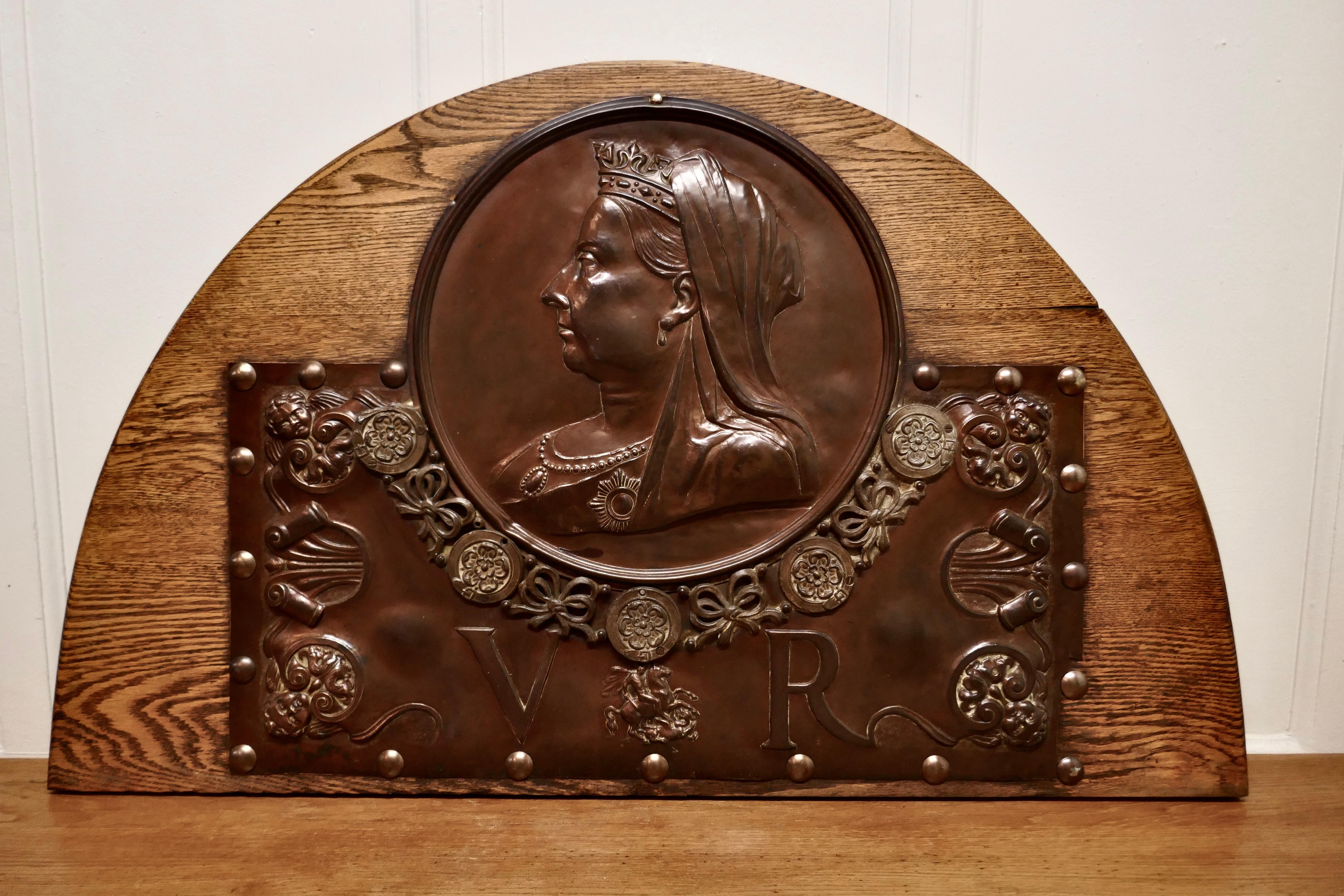 Large Victorian Queen’s head copper wall plaque 

The plaque is from the 1890s , it was originally wall hung, it has been mounted on polished Oak 
This is a superb decorative piece dating from the late 19th Century, it is 25” tall, 41” wide and