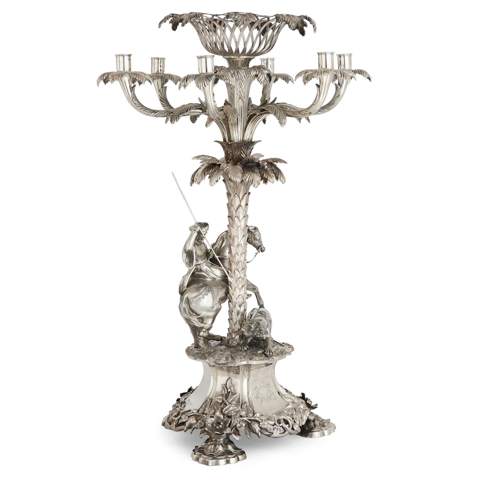 Large Victorian Silver Orientalist Equestrian Centrepiece Edward Barnard & Sons
English, 1851
Height 77cm, diameter 51cm

This exquisite silver centrepiece, crafted in 1851 by Edward Barnard & Sons, exemplifies both exceptional craftsmanship and the
