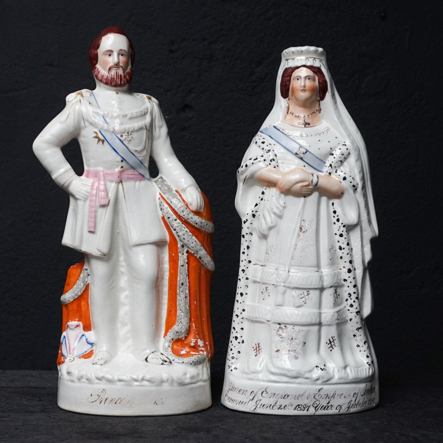 Set of 19th century ceramic Victorian Staffordshire figurines of Queen Victoria and Prince Albert.
Each with gilded trim and polychrome enamels.

Antique Queen Victoria of England ceramic Victorian figurine. 
The gold gilt script on Victoria's base
