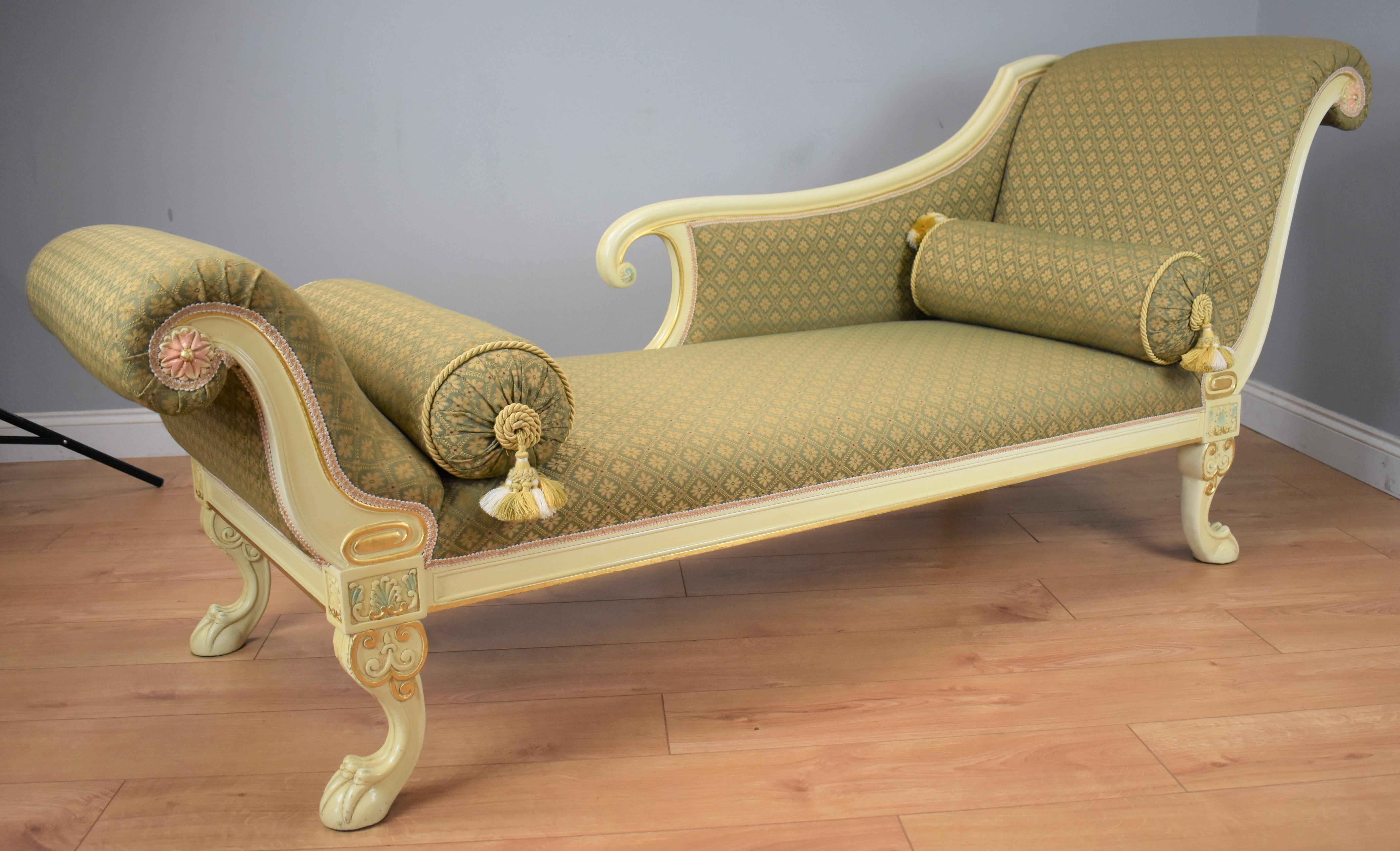 20th century large Victorian style painted chaise lounge in very nice condition with scroll ends with detailed flower to centre standing on claw feet. The upholstery is in good condition having been recently upholstered in a green patterened fabric,