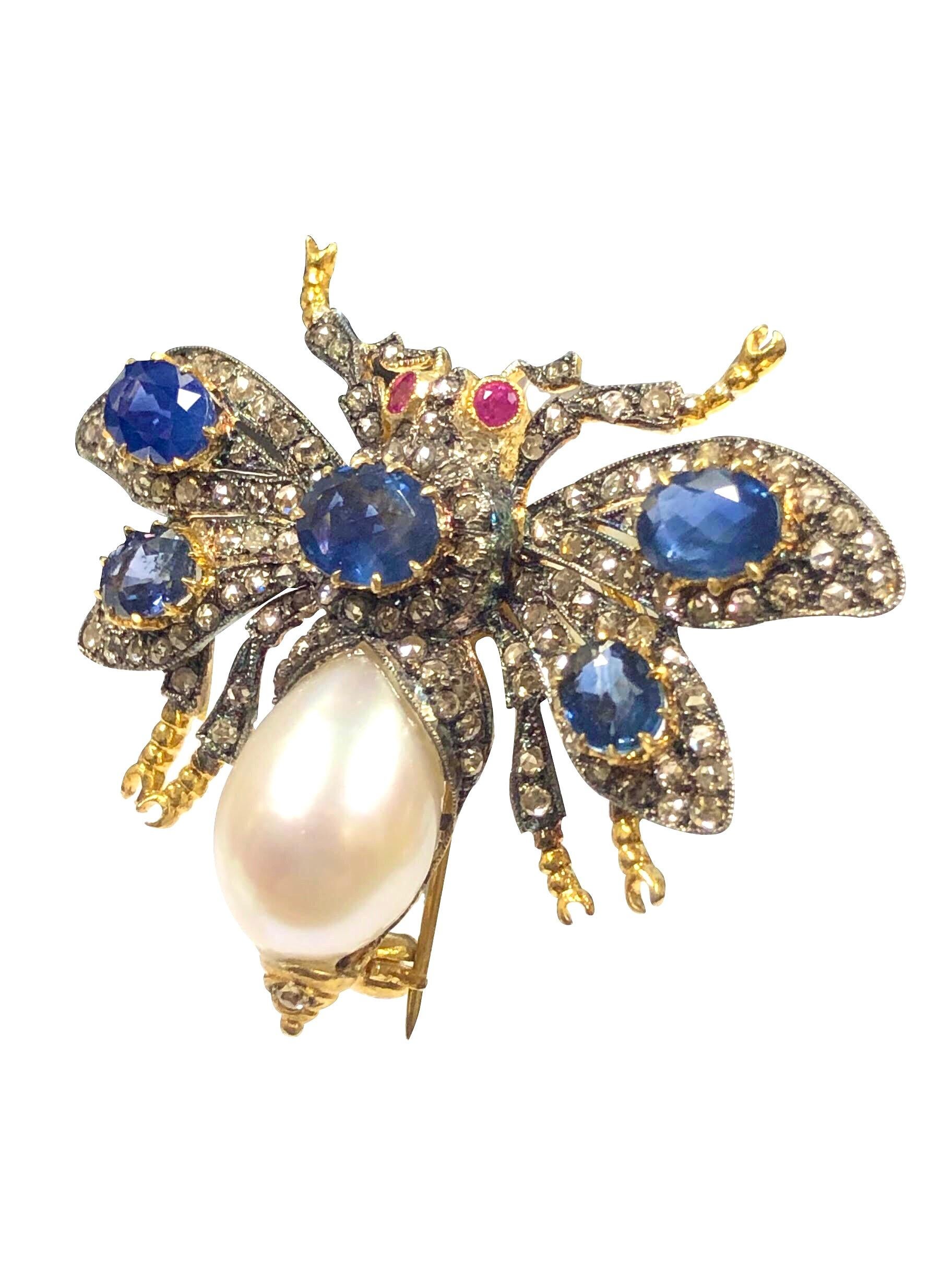 Silver top with Gold back Bug Brooch, measuring 2 inches from Wing end to end and 1 3/4 inches in length, set with a 15 X 10 M.M. Pearl for the body, Ruby Eyes and The movable wings are further set with Rose Cut Diamonds totaling approximately 2