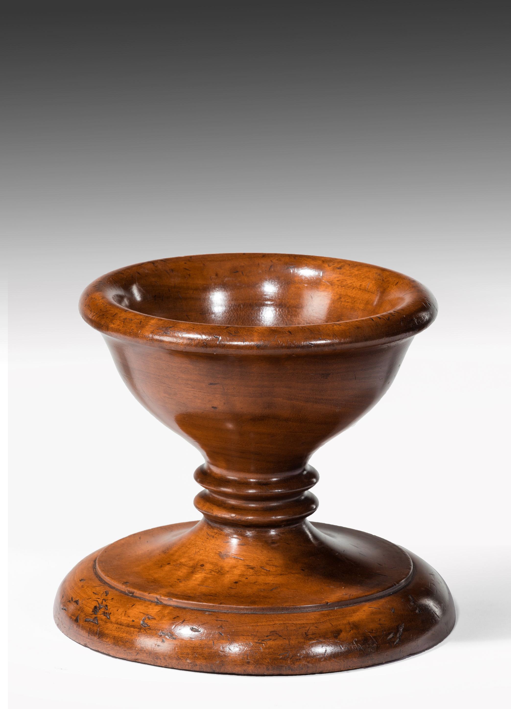 A large mid-19th century walnut treen master table salt.

English circa 1850.

Of excellent patina and color the bowl having an everted rim on a short turned stem and large moulded circular raised base. 

In excellent condition this imposing