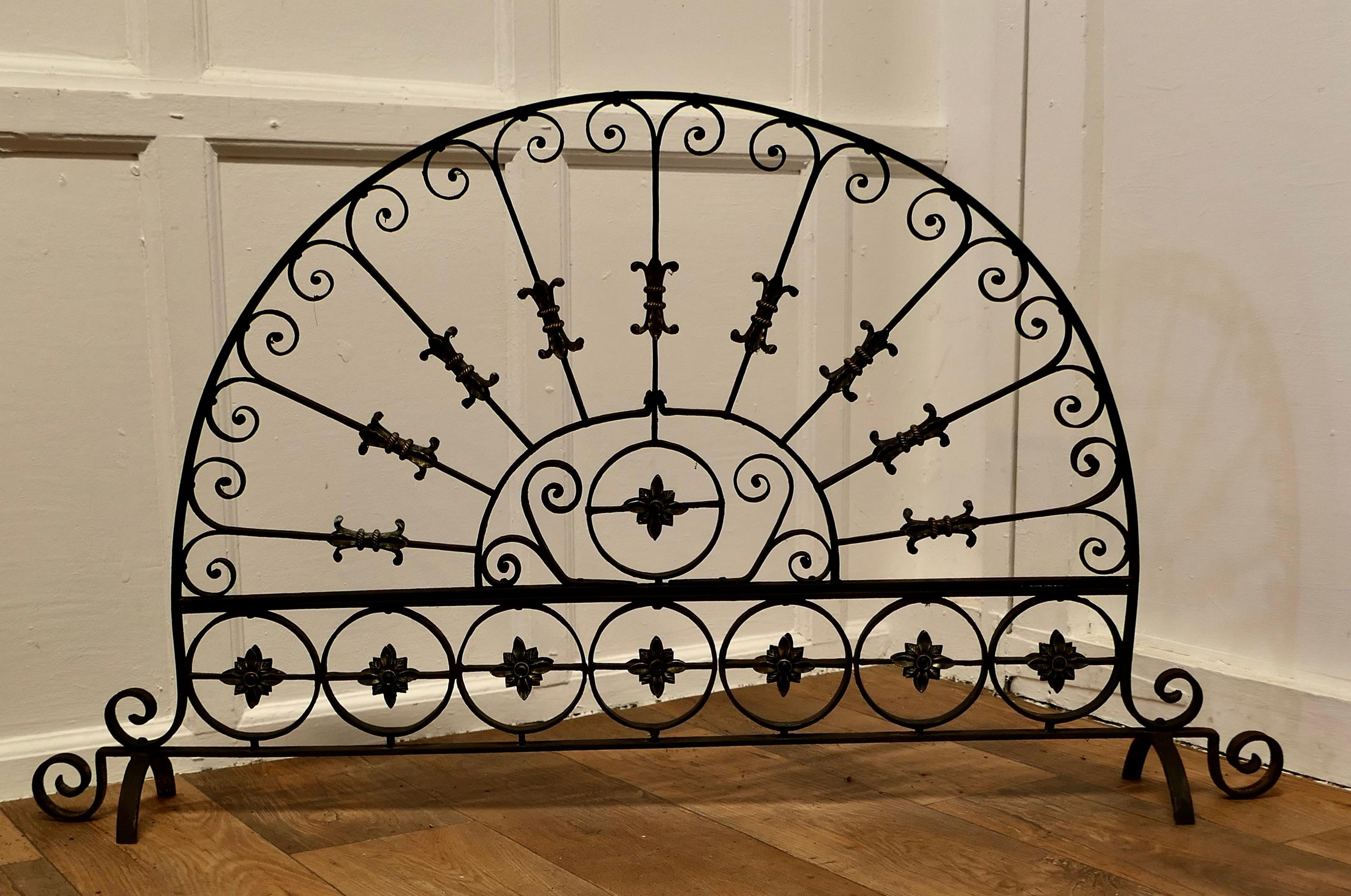 Large Victorian Wrought Iron Fan Shaped Fire Screen

This is an intricate and very attractive piece, the wrought iron work is superbly executed and embellished with brass flowers and decorations
In good sound, heavy condition and a very attractive