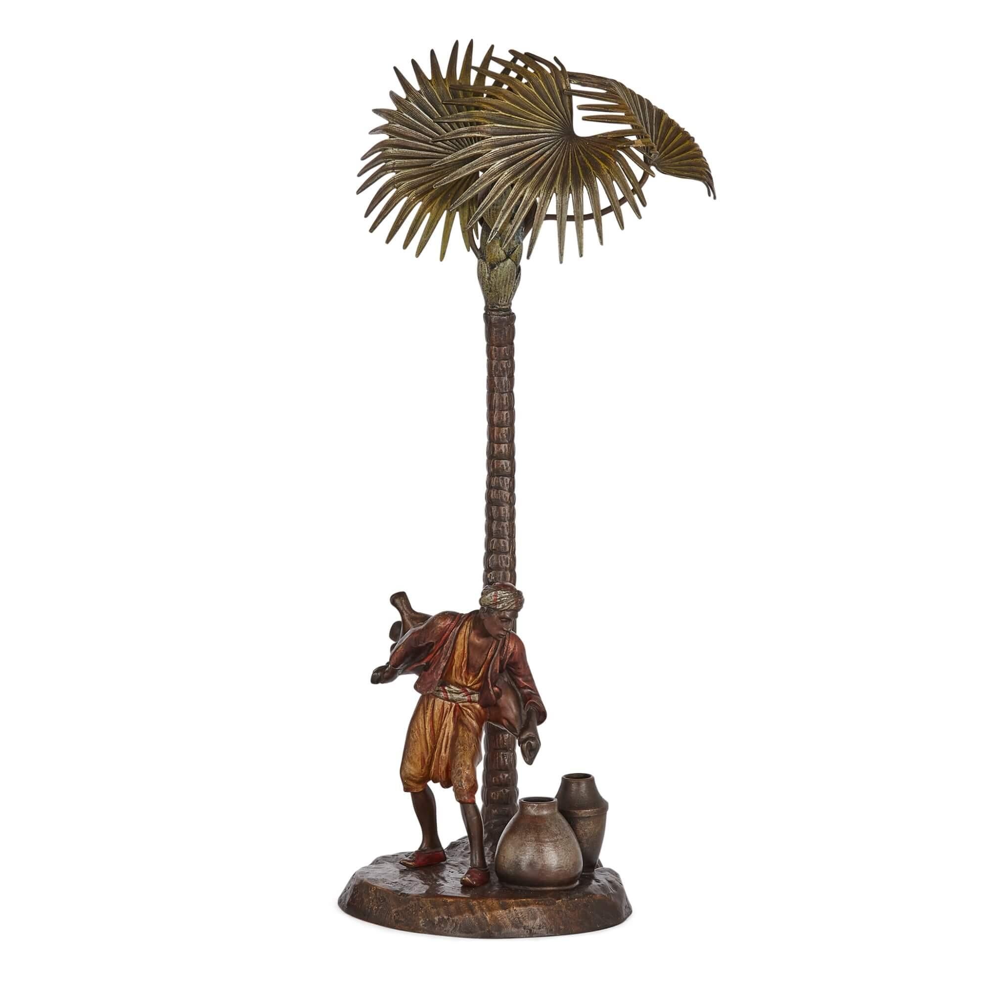 Large Viennese Orientalist lamp in cold-painted bronze 
Austrian, c. 1910
Height 44cm, width 18cm, depth 15cm 

This excellent antique bronze sculpture depicts a simple yet highly authentic scene.

The lamp depicts an Arab transferring water to a