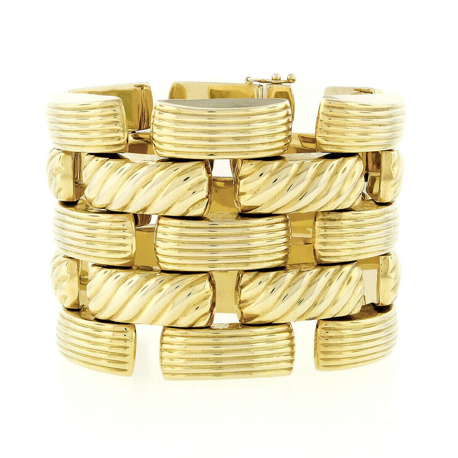 Here we have an incredible, large, and very wide vintage bracelet crafted from solid 14k yellow gold. This heavy and well made bracelet is structured from numerous alternating groove and cable link design that sit flexibly on the wrist with open