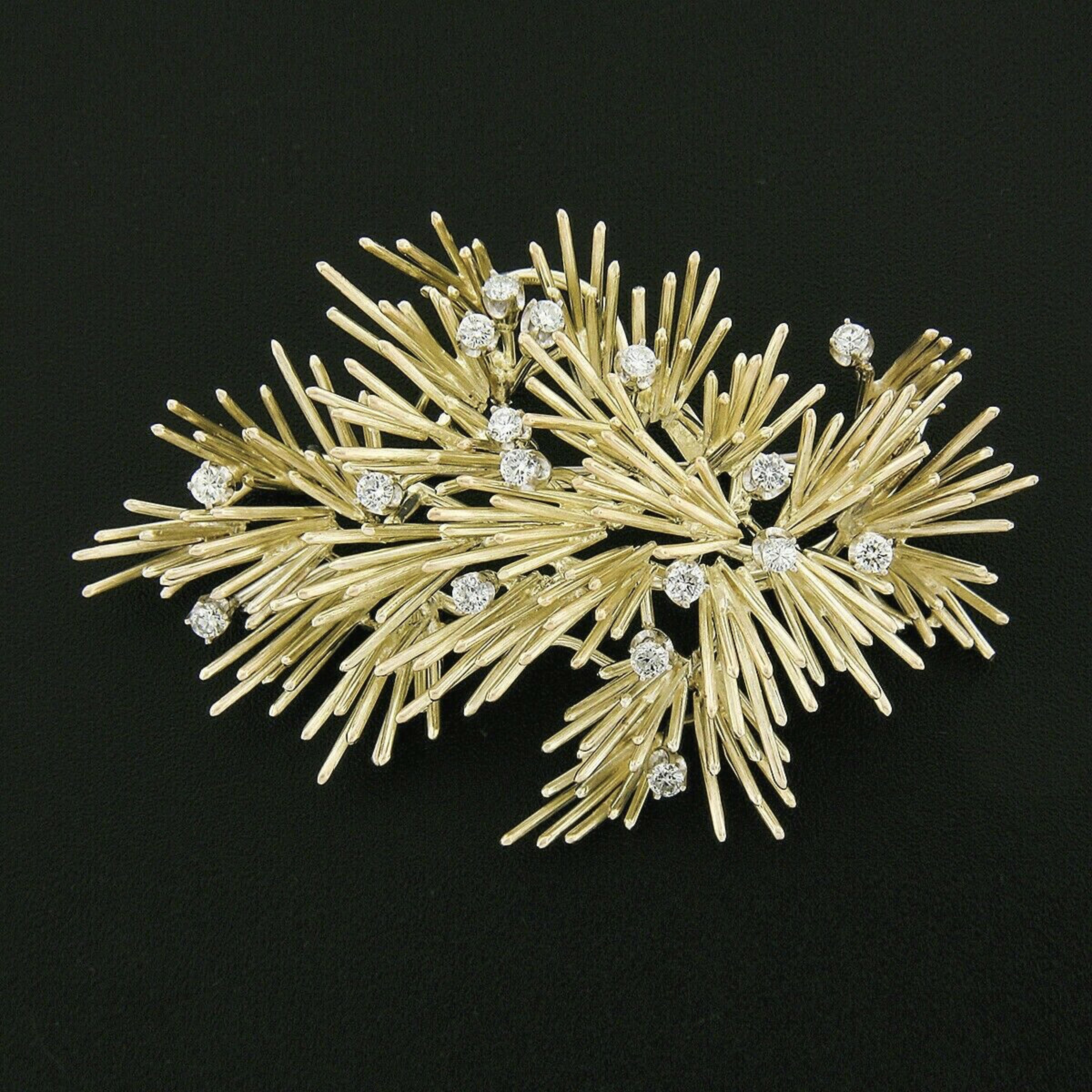 This outstanding vintage brooch/pin is well crafted in solid 14k greenish yellow gold and features a large handmade wire spray design set with fine quality diamonds throughout. These stunning round brilliant cut diamonds are perfectly prong set,