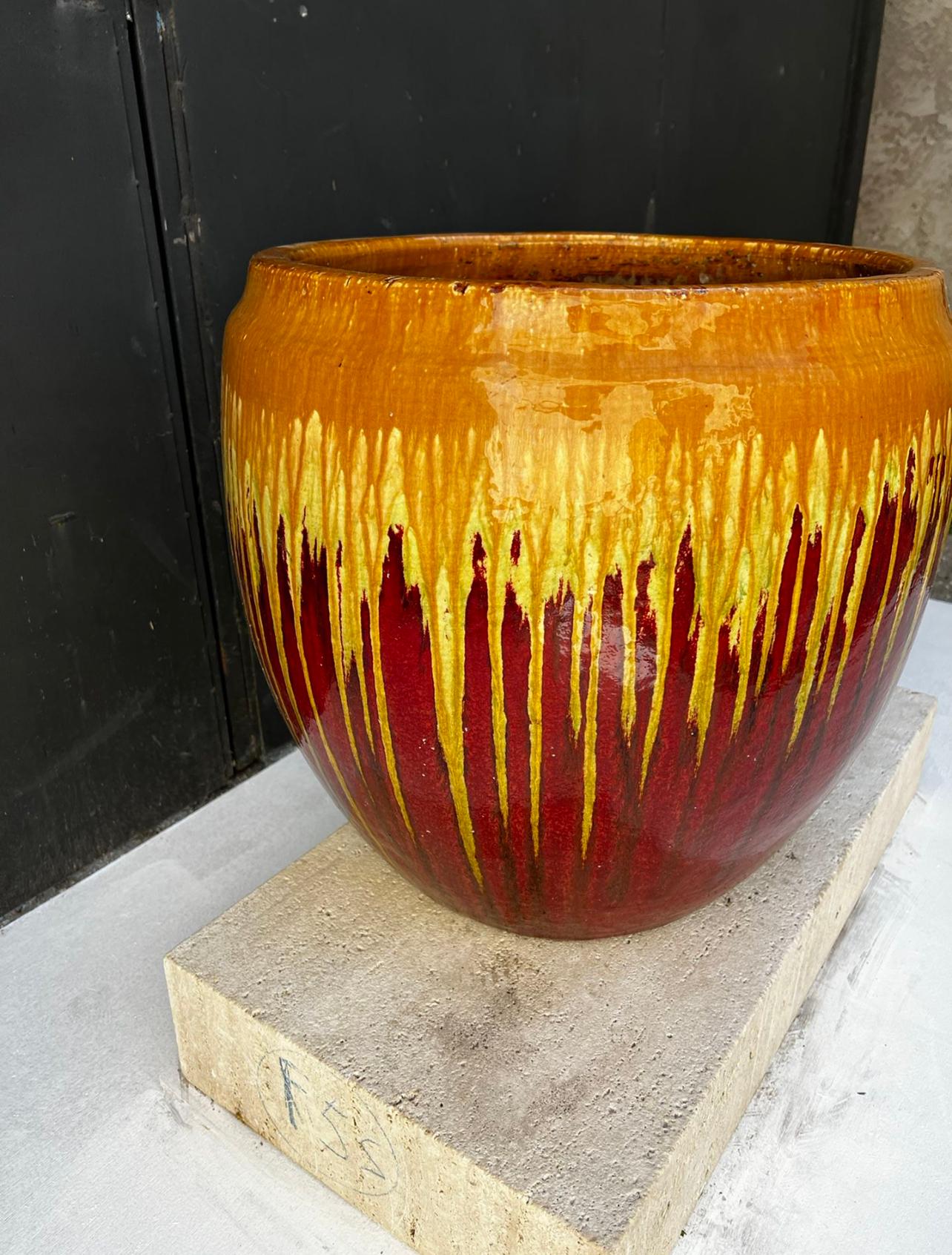 Large multi colored vintage planter, with drain hole. Glazes colors range from tangerine, bright yellow and ox blood red 
