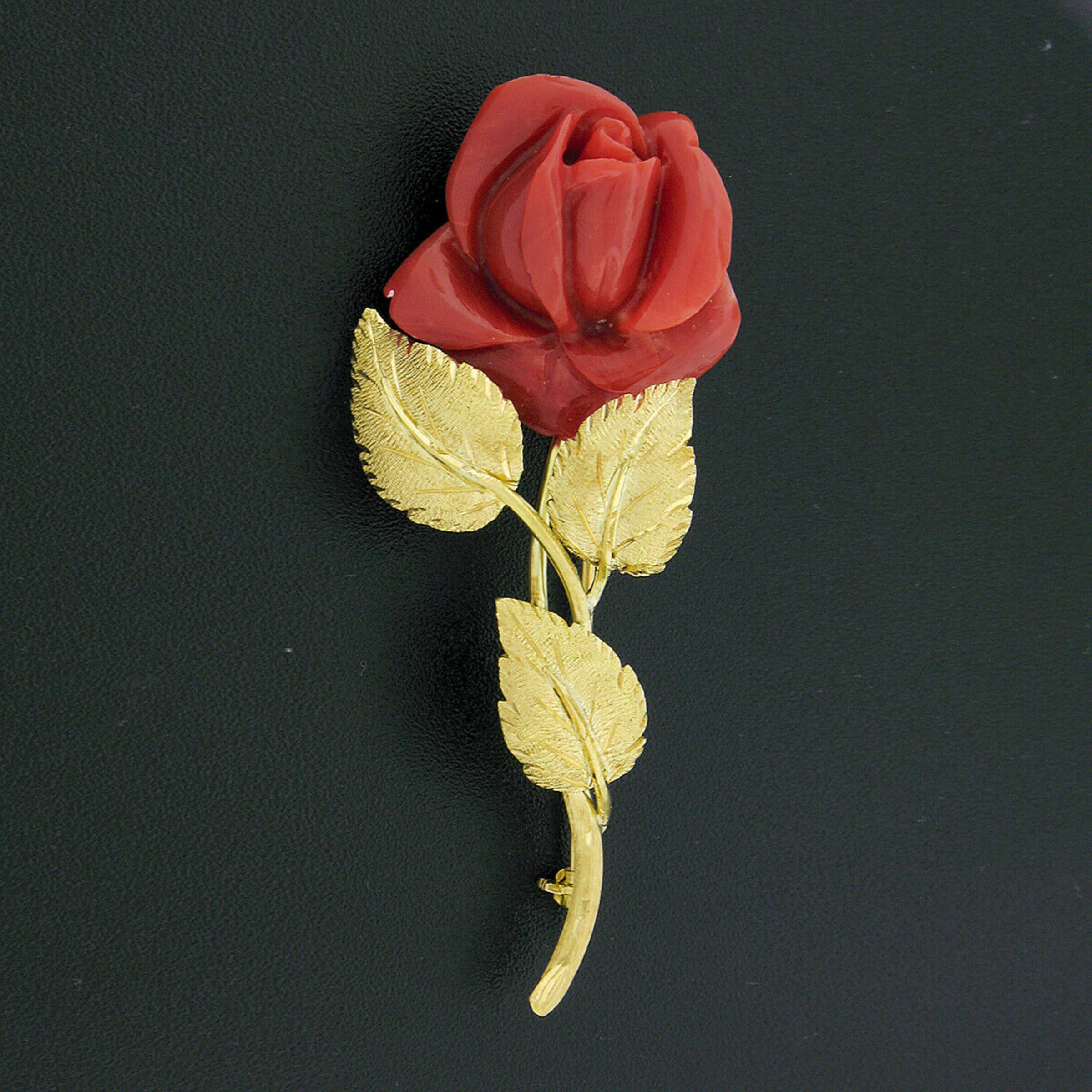 This large and very well-made vintage pin brooch was crafted from solid 18k yellow gold. It features a fine, GIA certified, coral neatly set on a gold stem adorned with incredibly detailed hand-finished leaves. The oxblood coral is masterfully