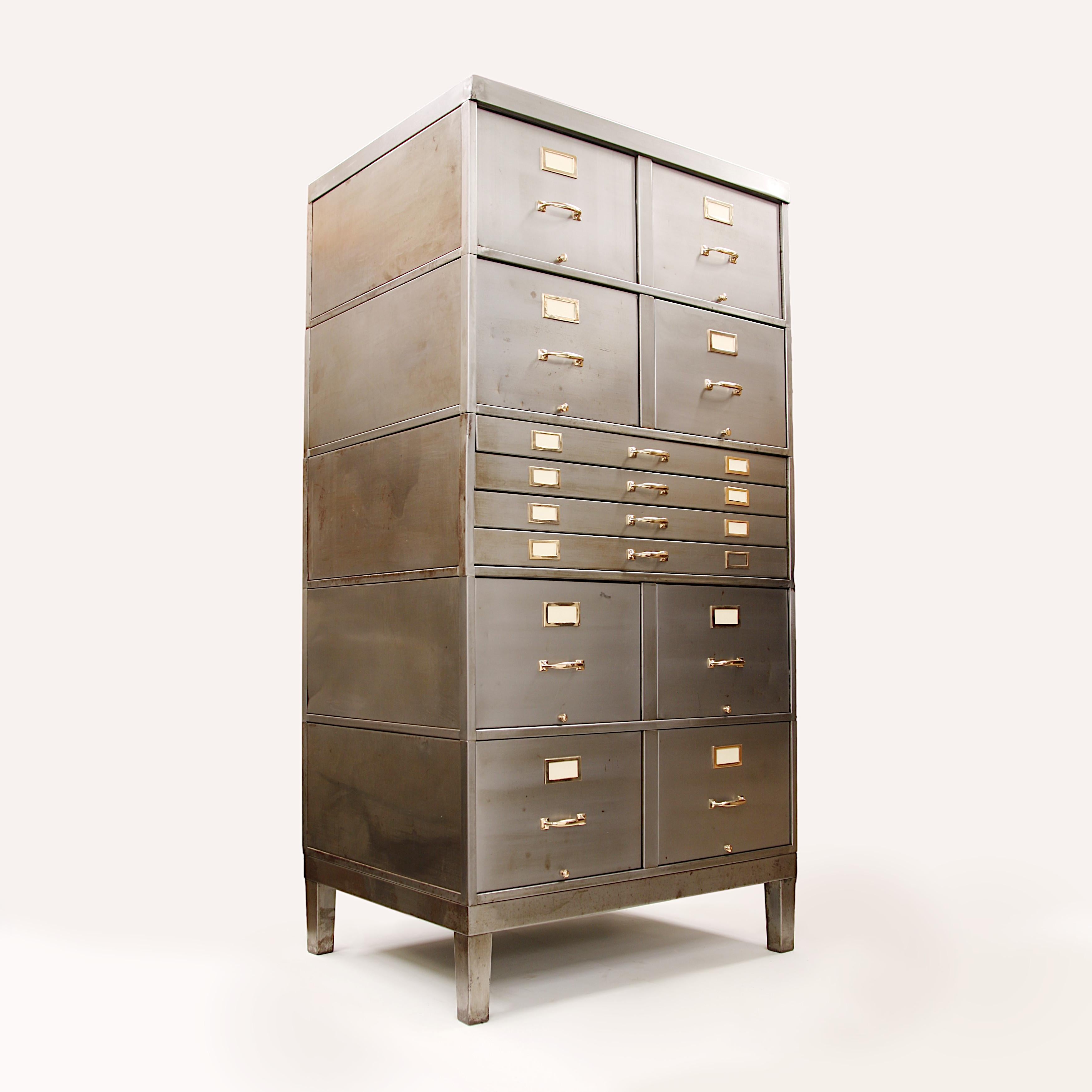 This monumental file cabinet was recently hand-stripped and polished to showcase its steel and brass construction. Cabinet features

- Tempered steel construction
- Solid brass hardware
- (8) Large Legal File Drawers (dimensions: 26