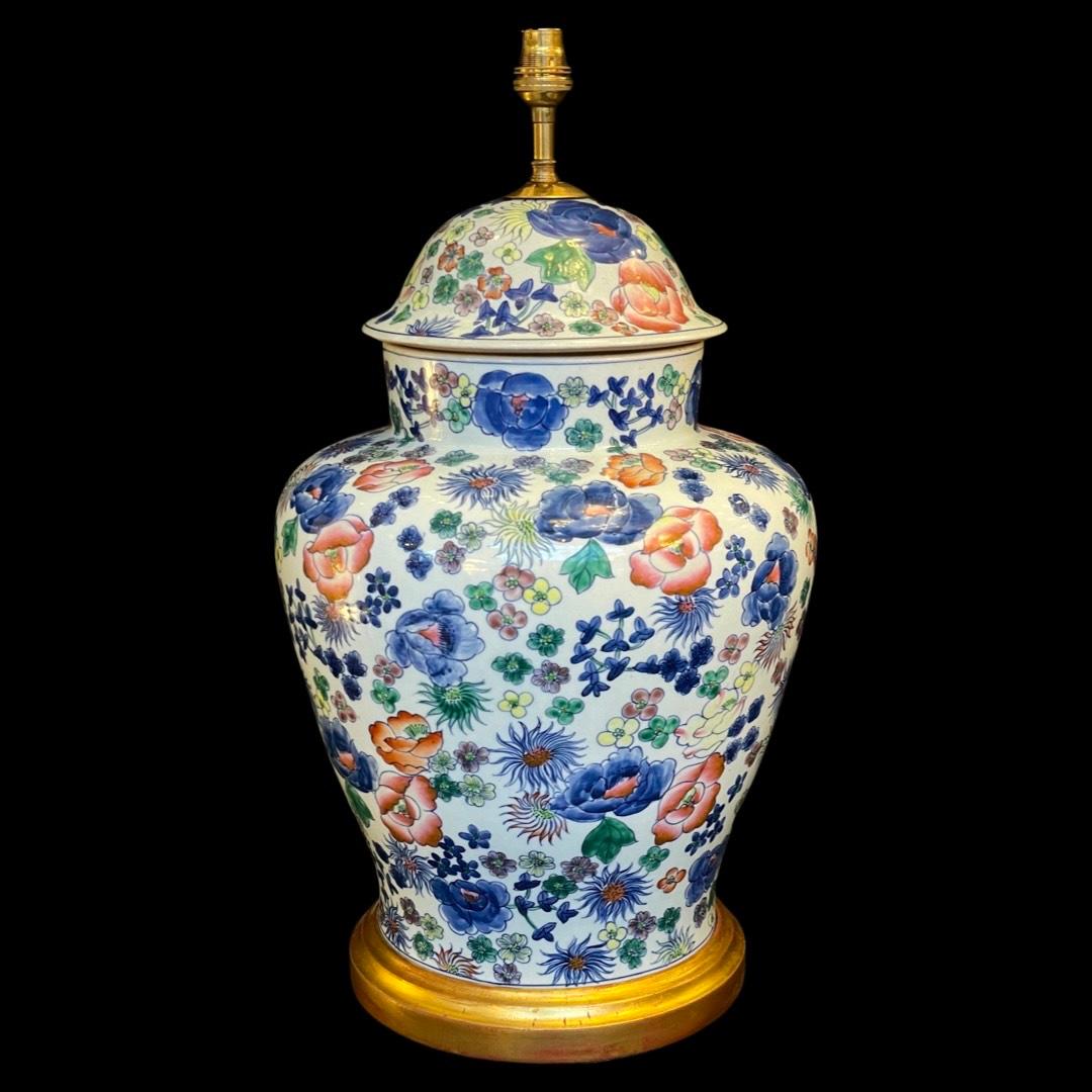 This unique piece effortlessly marries artistry and functionality, boasting a meticulously hand-painted multicolored floral design that dances upon a pristine white ceramic canvas.

The large jar, a testament to vintage charm, now finds new purpose