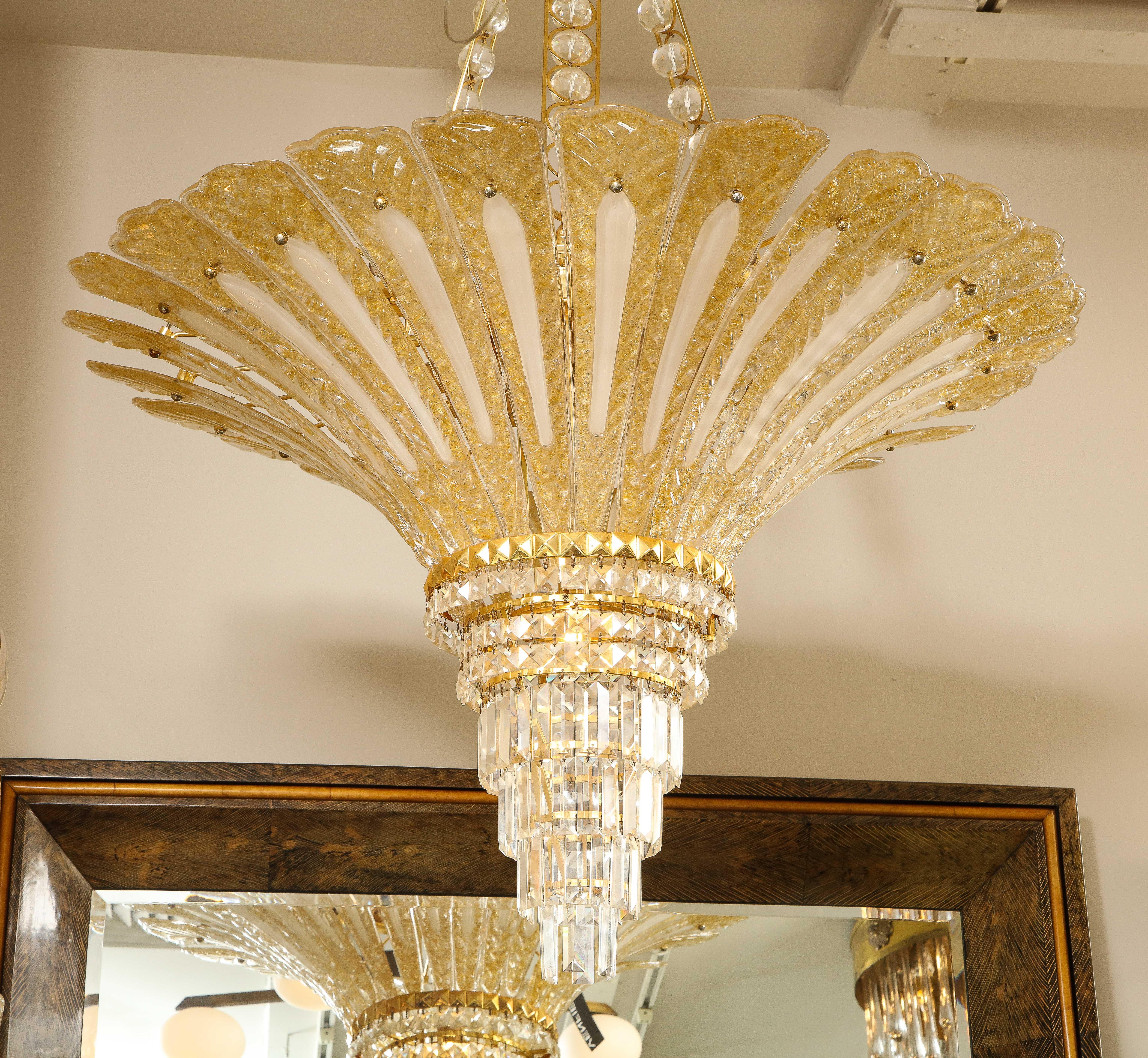 This is an impressive vintage 24-karat gold-flecked Murano glass palm tree chandelier, with faceted and cut baguette crystals hanging at the end of the chandelier. The structure is made of brass, plated in 24-karat gold and, uniquely suspended by