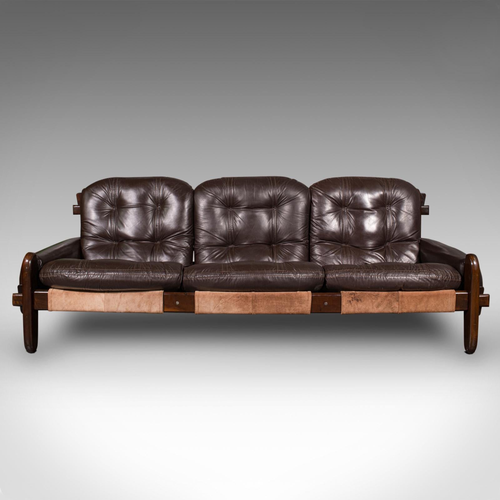 This is a large vintage 3 seat sofa. A Brazilian, leather and Imbuia lounge settee designed by Jean Gillon for Probel, dating to the mid 20th century, circa 1970.

Exceptional mid-20th century lounge sofa, graced with designer appeal and superb