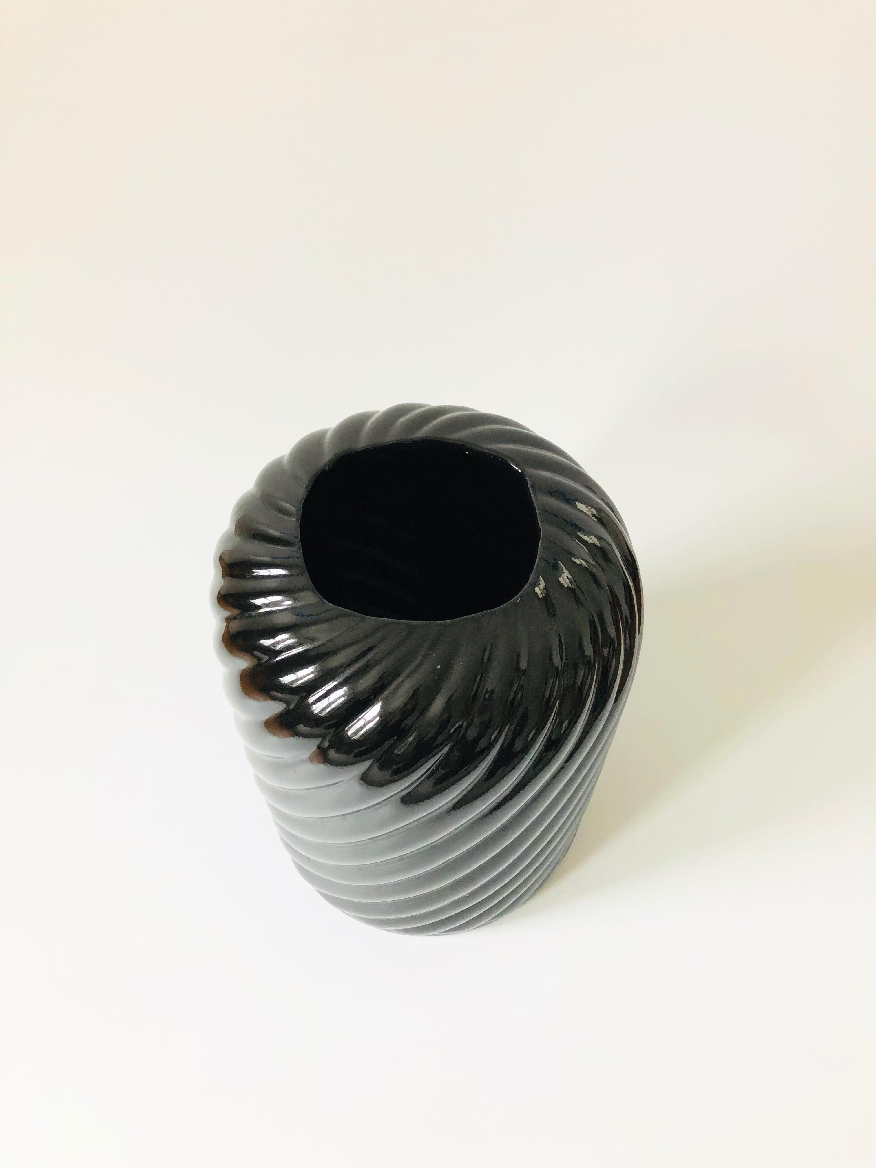 An extra large vintage 80s modern ceramic vase. Nice cylinder shape with an embossed swirl design around the sides, finished in a glossy black glaze. A sculptural bold statement piece, perfect for using as a floor vase as well.
   