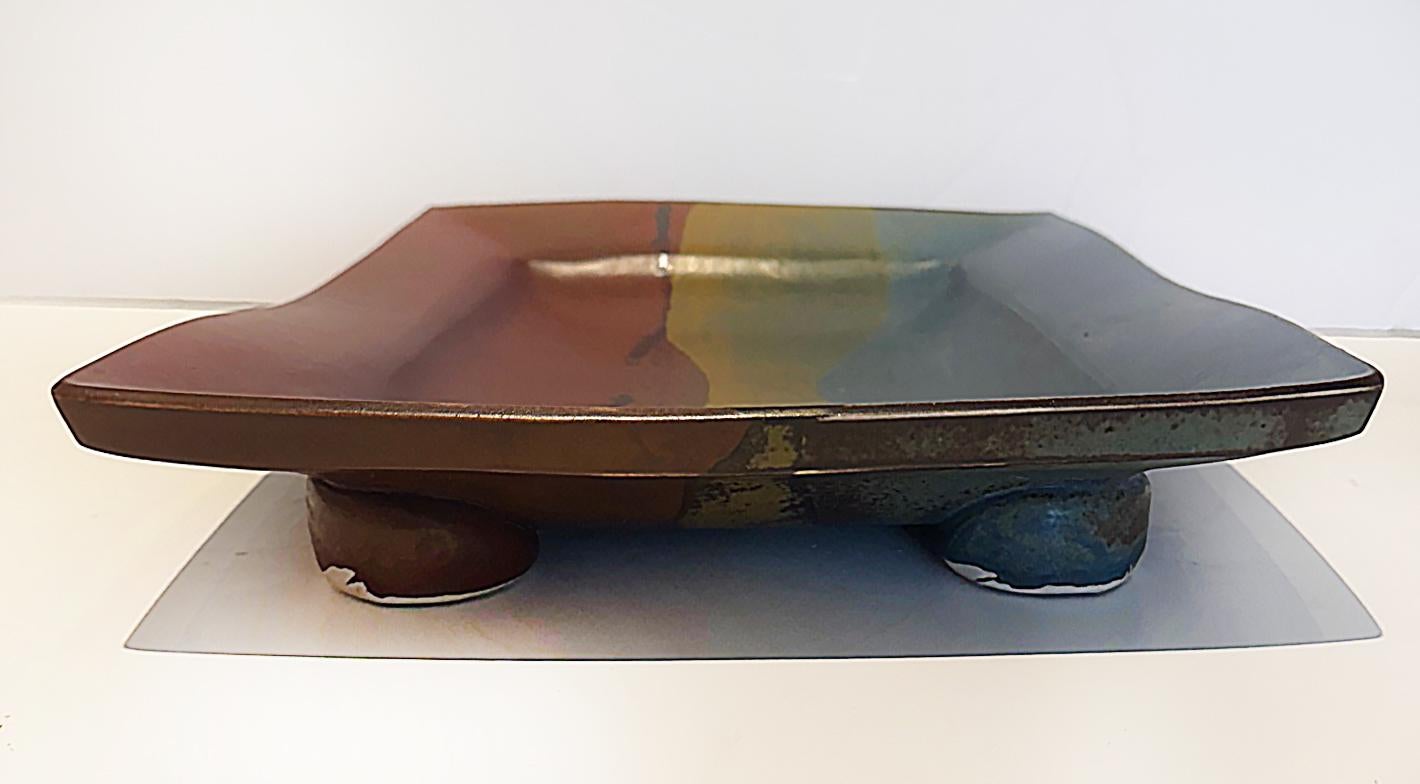 Großes abstraktes Studio Pottery Catchall Tablett mit Fuß,  Etikettiert

Zum Verkauf angeboten wird ein großes Tablett aus Keramik, glasiert in satten Blau-, Hellbraun- und Dunkelrot-Tönen. Das Stück ist solide und hat die Original-Etiketten des