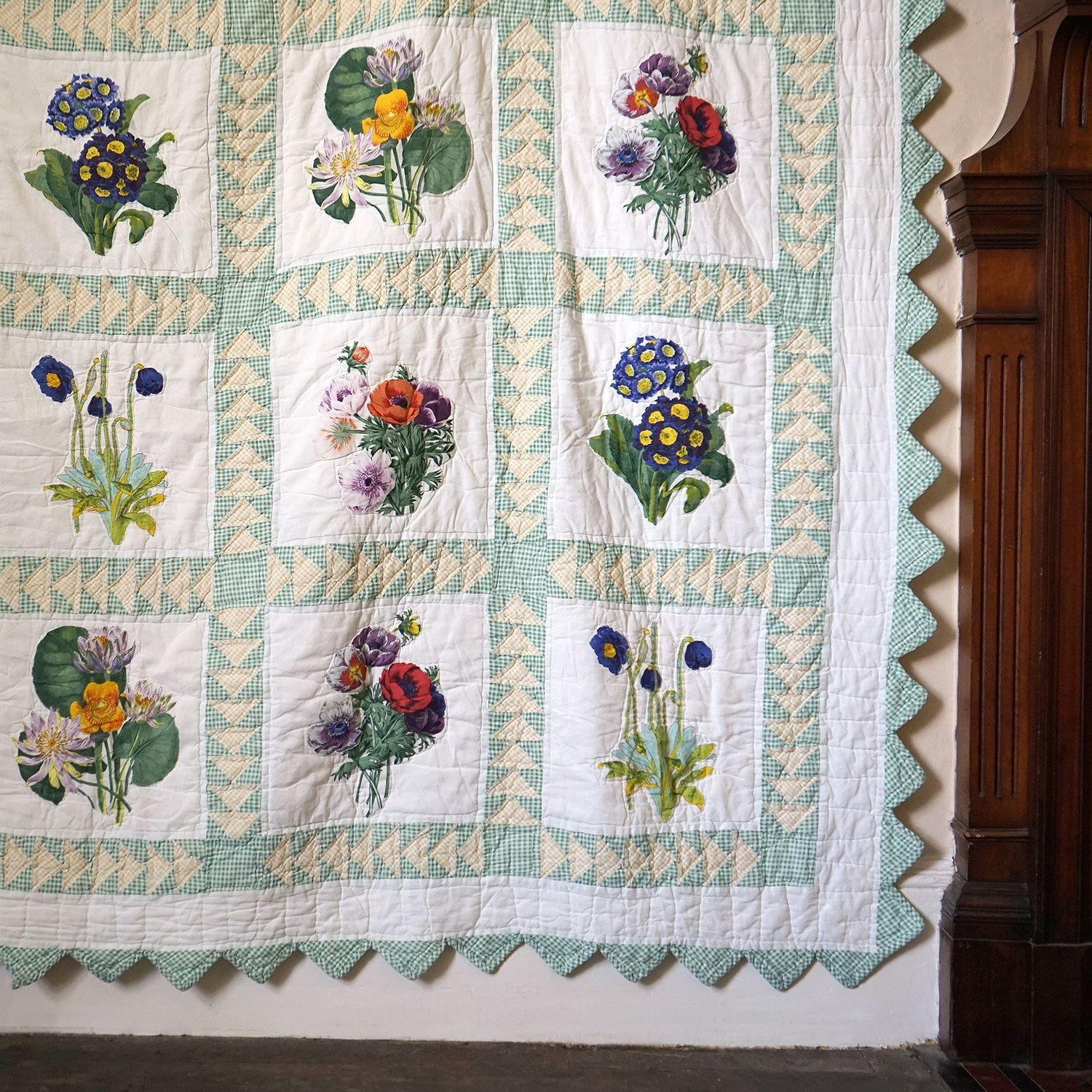 Vintage King-Sized Handmade blanket quilt

Originating from Kansas and probably dating from the mid-20th century.

White ground with a green gingham grid with yellow gingham triangular details that showcases 25 different floral panels.

Green